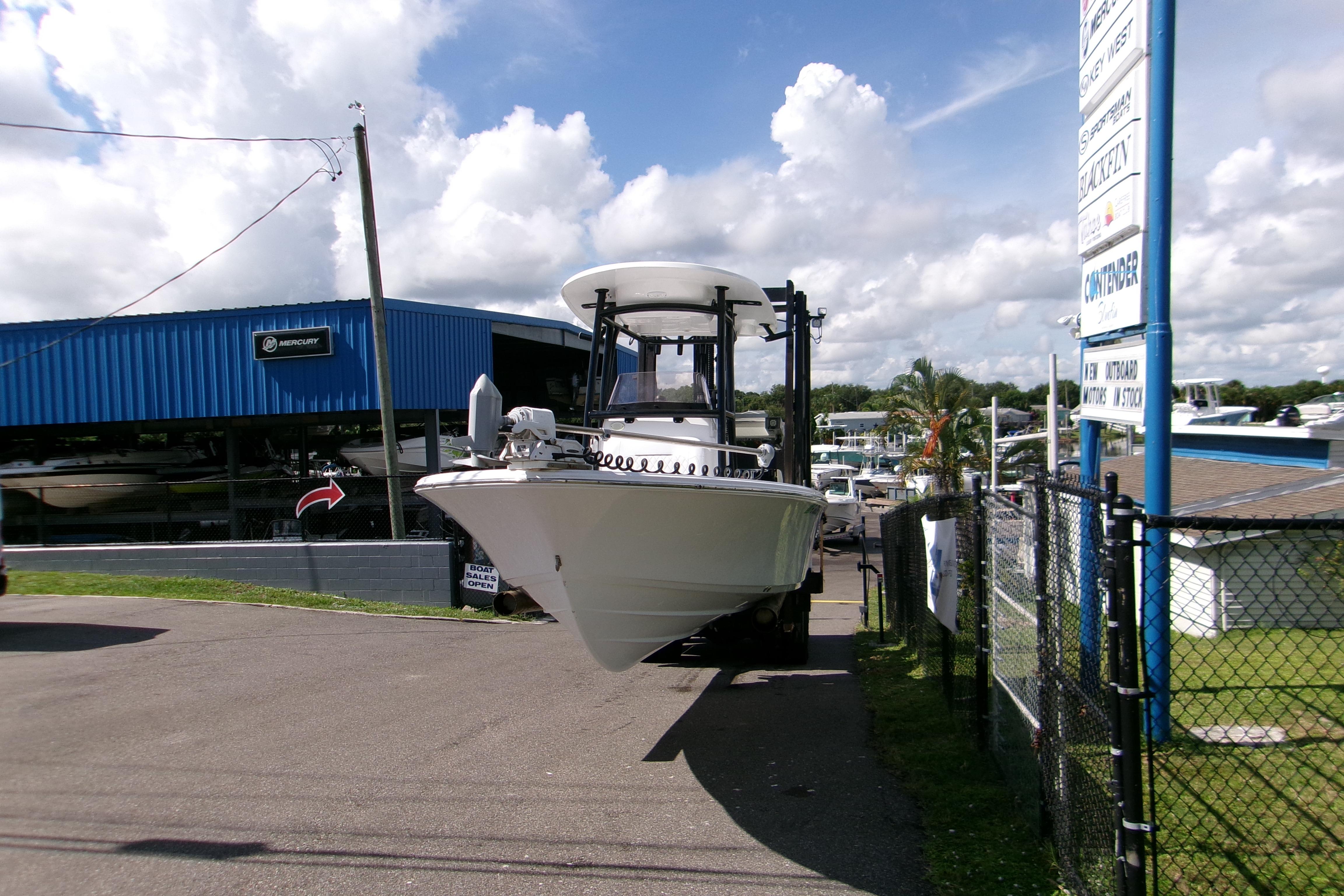 2024 Sportsman Masters 227 Bay Boat at dealership, sunny day, blue sky, outdoor display.