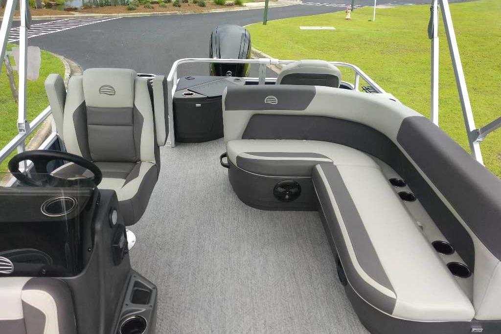 2026 Sun Tracker Bass Buggy 18 DLX pontoon boat interior with seating and steering console.