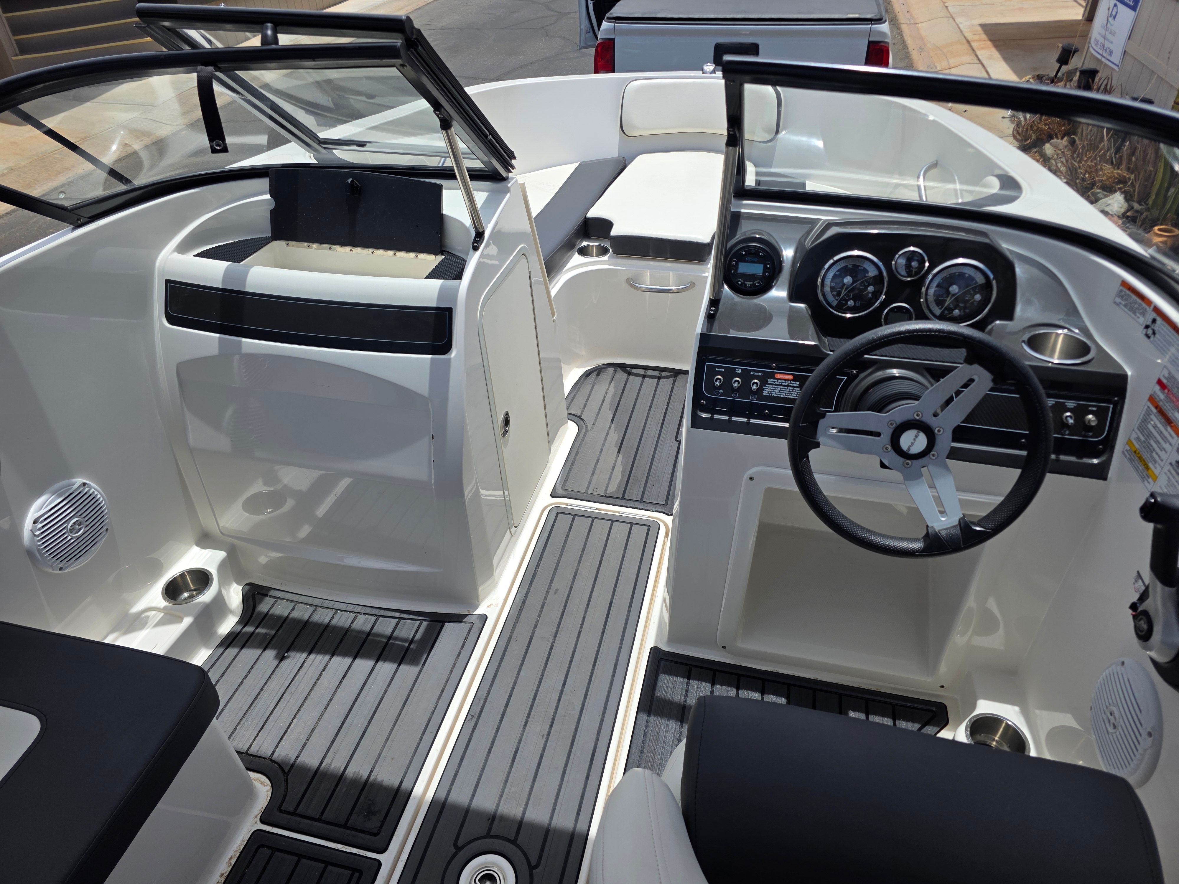 The image shows the cockpit of a 2021 Bayliner VR4 Bowrider I/O with modern instruments.