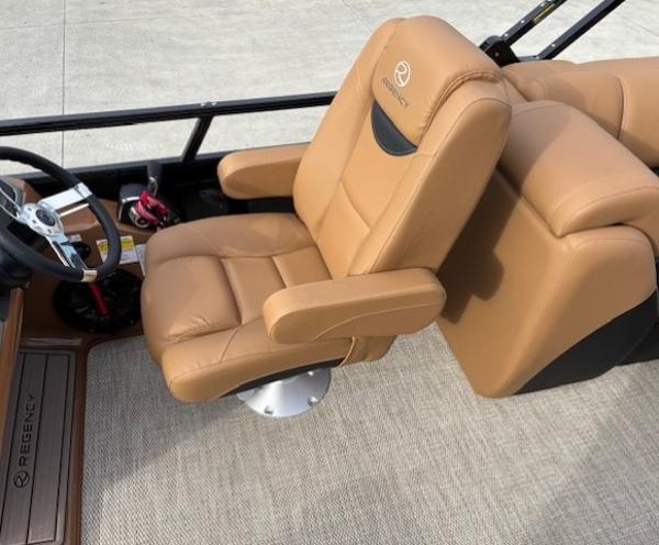 Luxurious tan seating in 2025 Regency 230 LE3 boat interior.