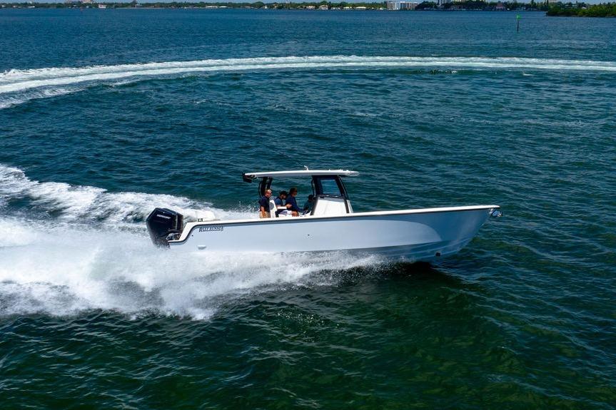2027 Reef Runner 340 boat cruising on open water, creating a wake.