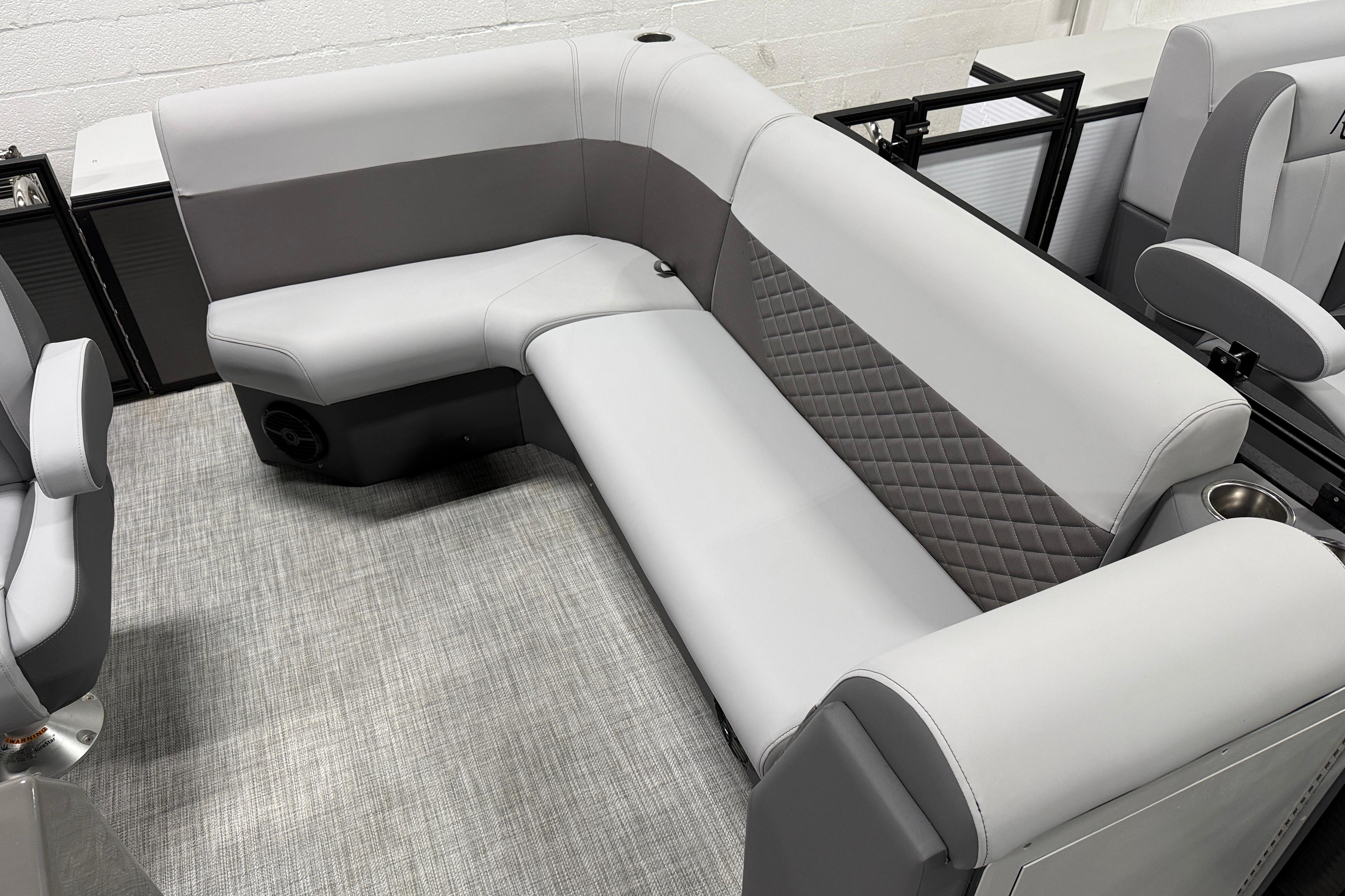 2026 Angler Quest 818 Panfish Cruise boat interior with gray seating and quilted design.