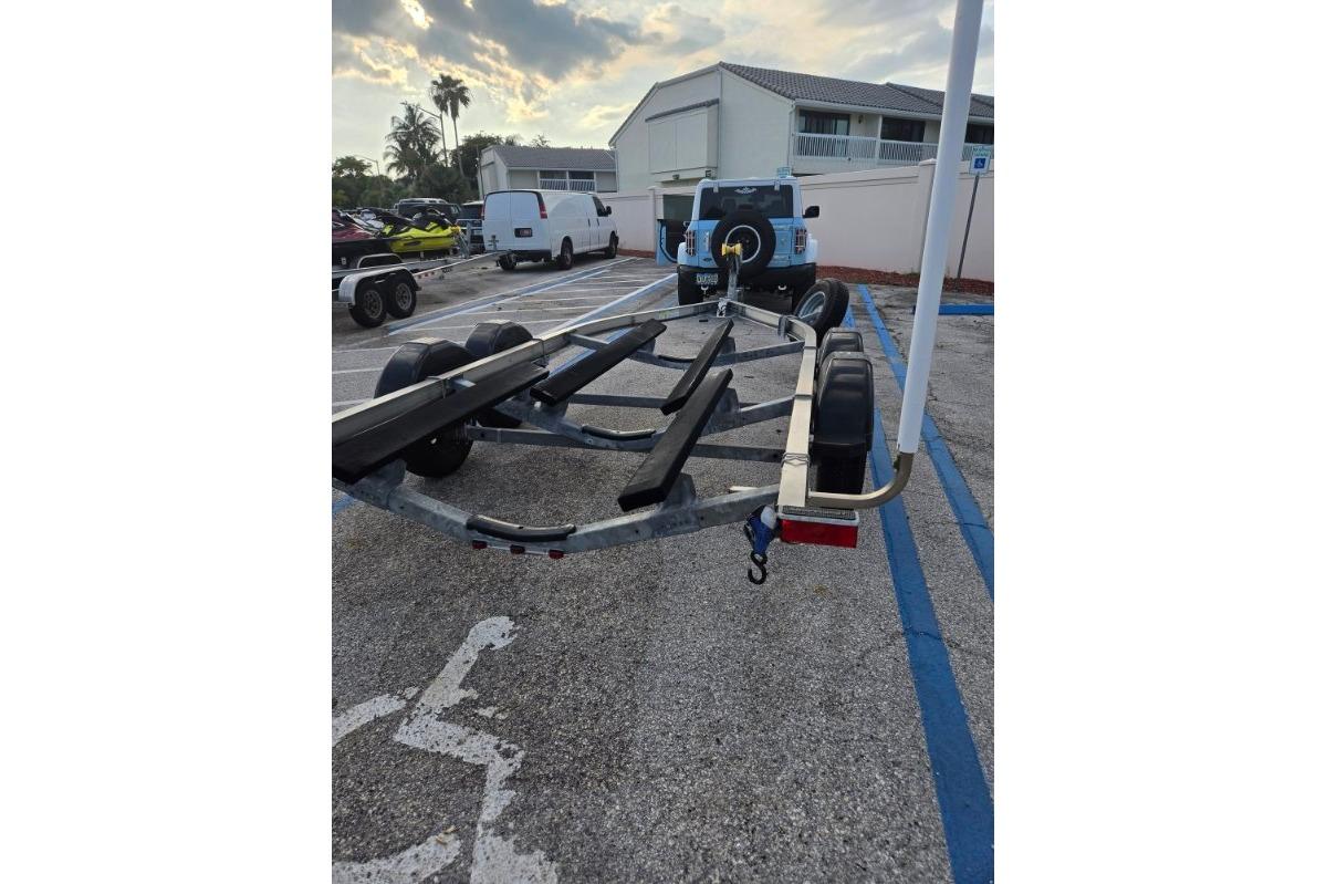 Boat trailer parked in a lot, ready for a 2024 Yamaha 222 FSH Sport E.