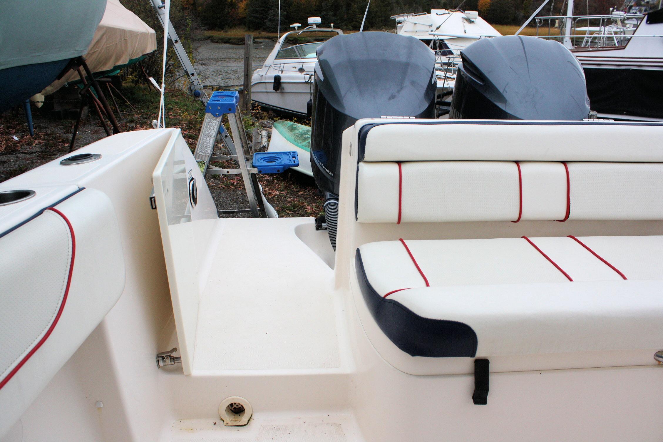 2013 Pursuit ST 310 Sport boat interior with cushioned seating and dual engines.