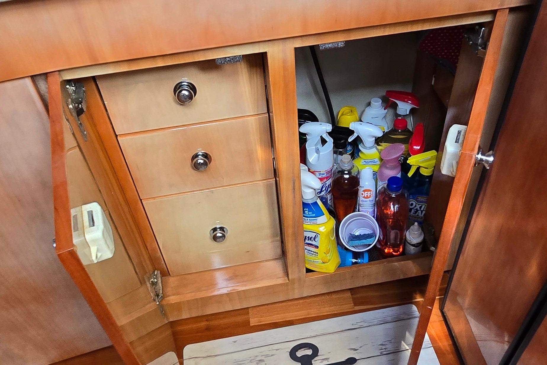 Cabinet in 2003 Regal Commodore 4260 yacht with cleaning supplies and drawers.