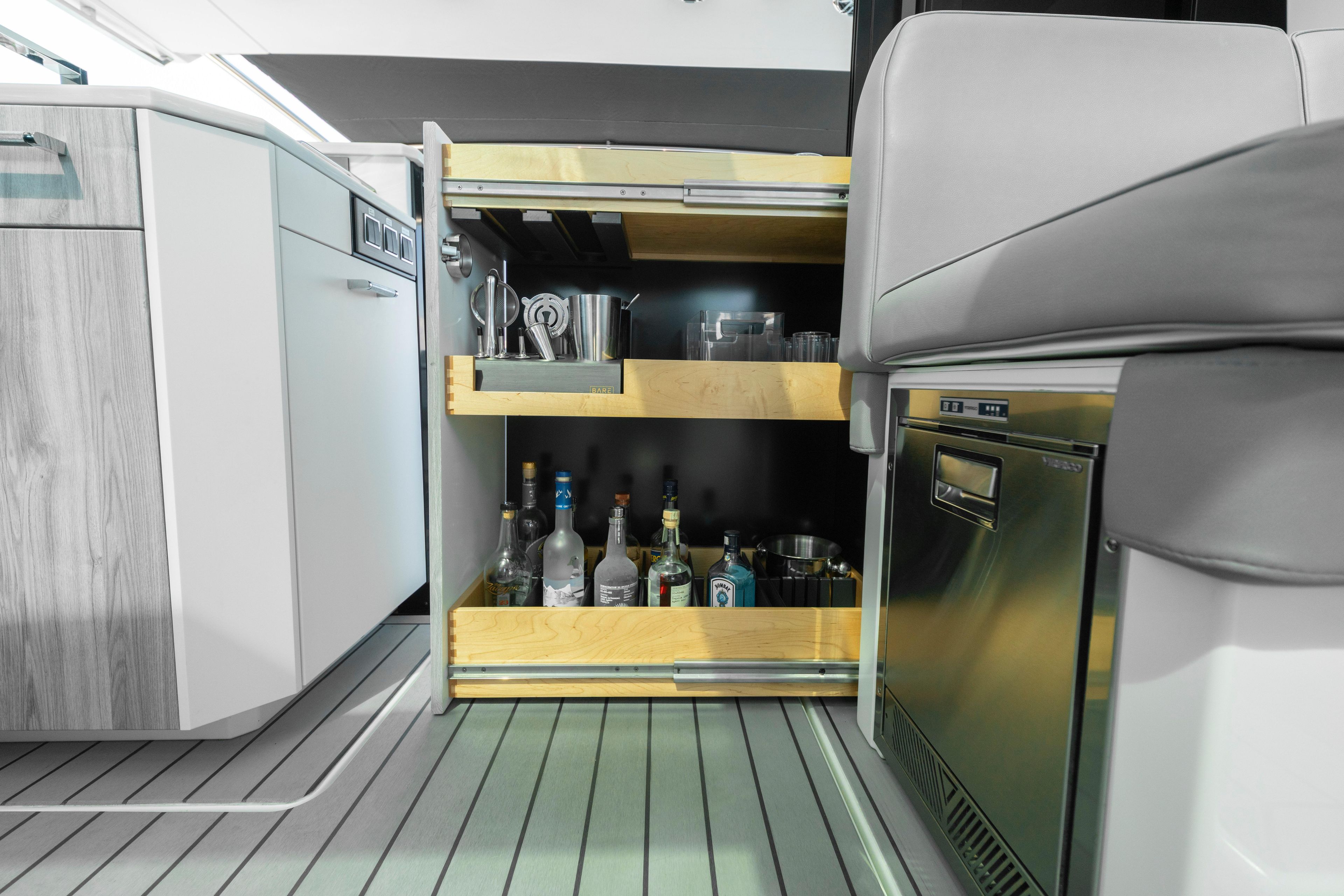 2022 Formula 500 Super Sport Crossover interior with open bar cabinet and modern kitchen amenities.