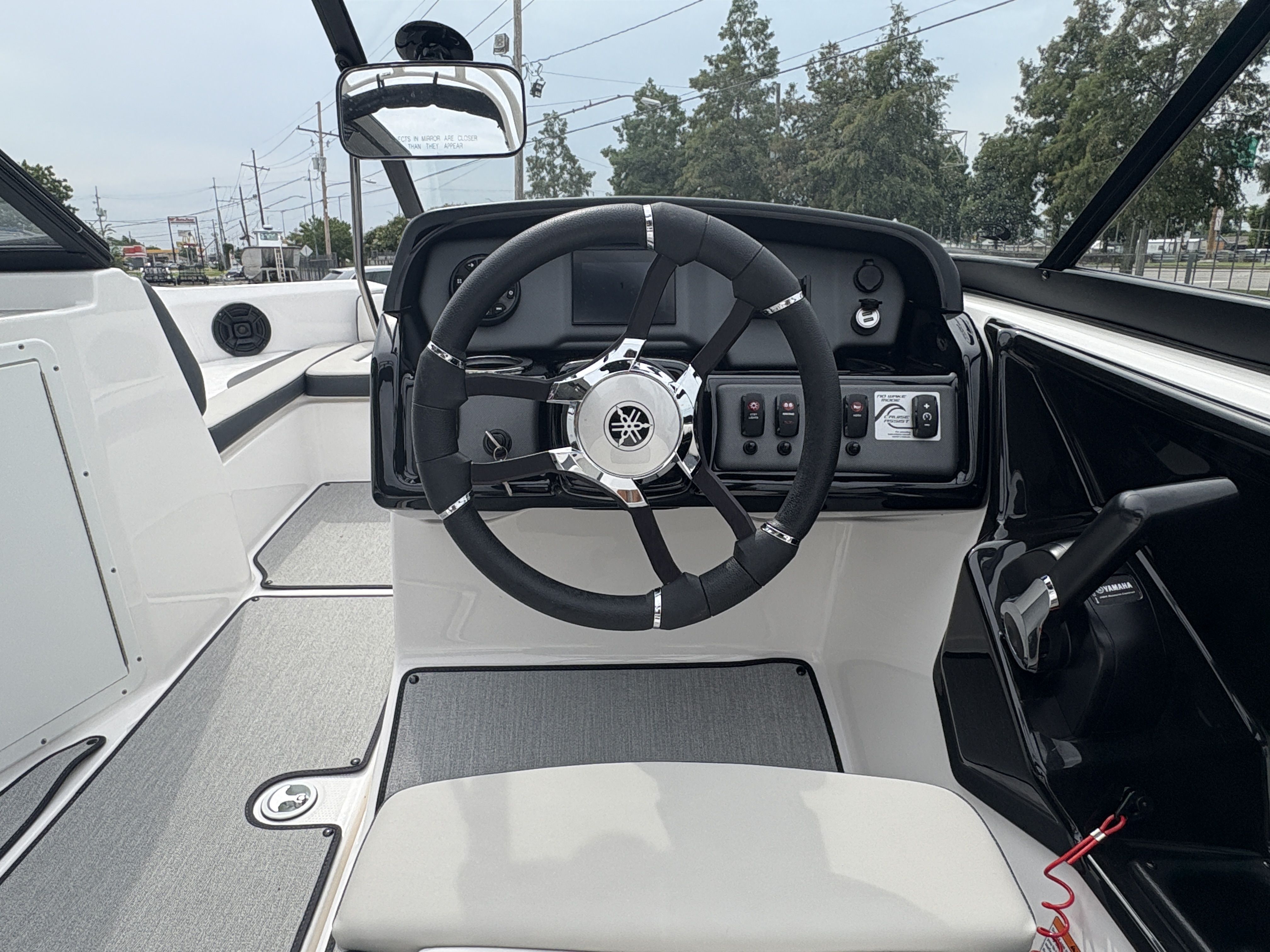 2024 Yamaha Boats AR 195 cockpit with steering wheel and control panel.