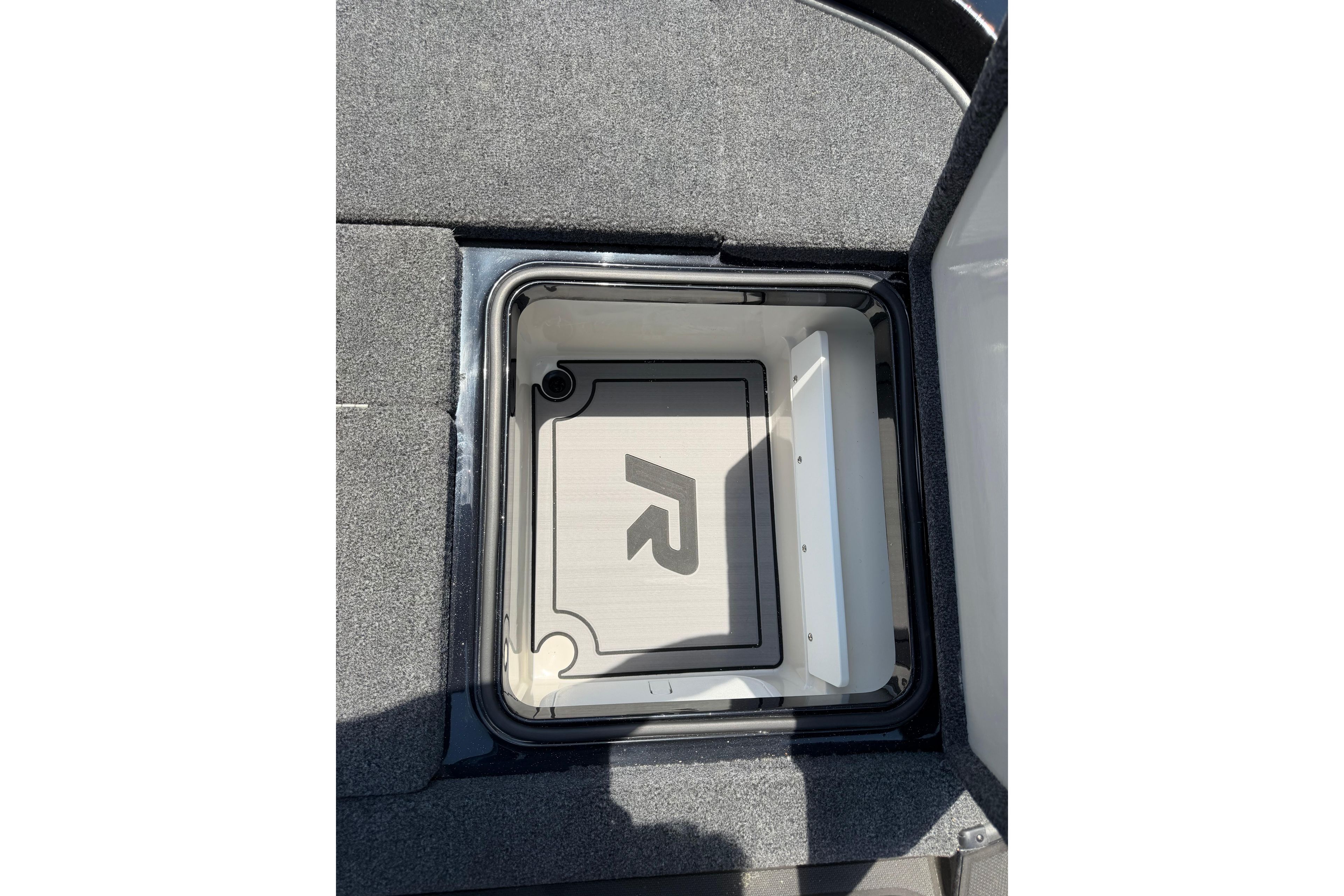 2023 Ranger Z520R storage compartment with logo, featuring carpeted interior.