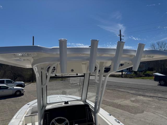 2025 Robalo 266 Cayman boat with T-top and rod holders under a clear blue sky.