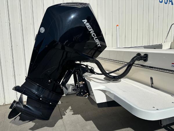 2023 Defiance Admiral 220 EX with Mercury outboard motor, docked near a white wall.