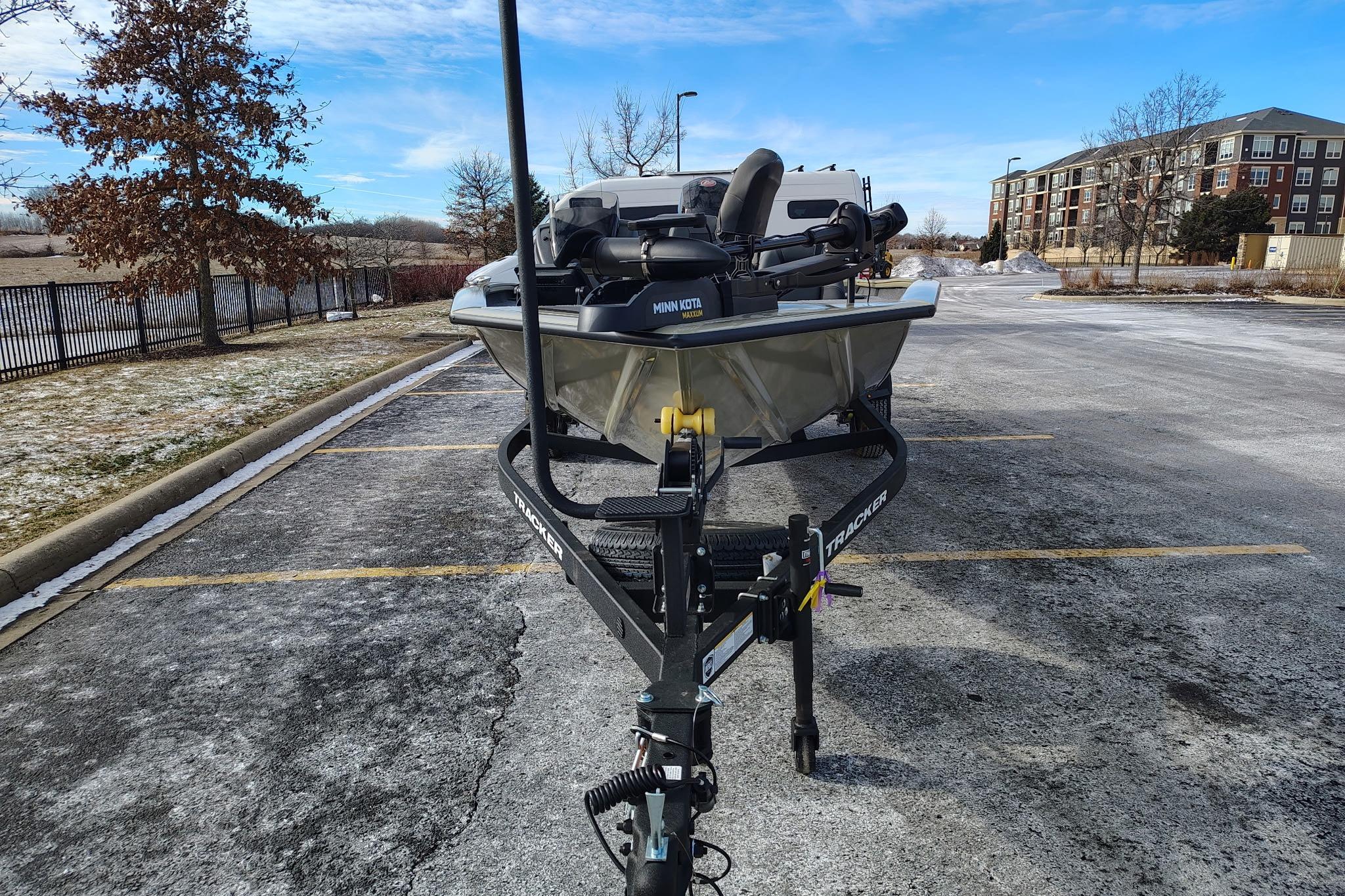 2026 Tracker Pro Team 195 boat on trailer in parking lot, winter setting.