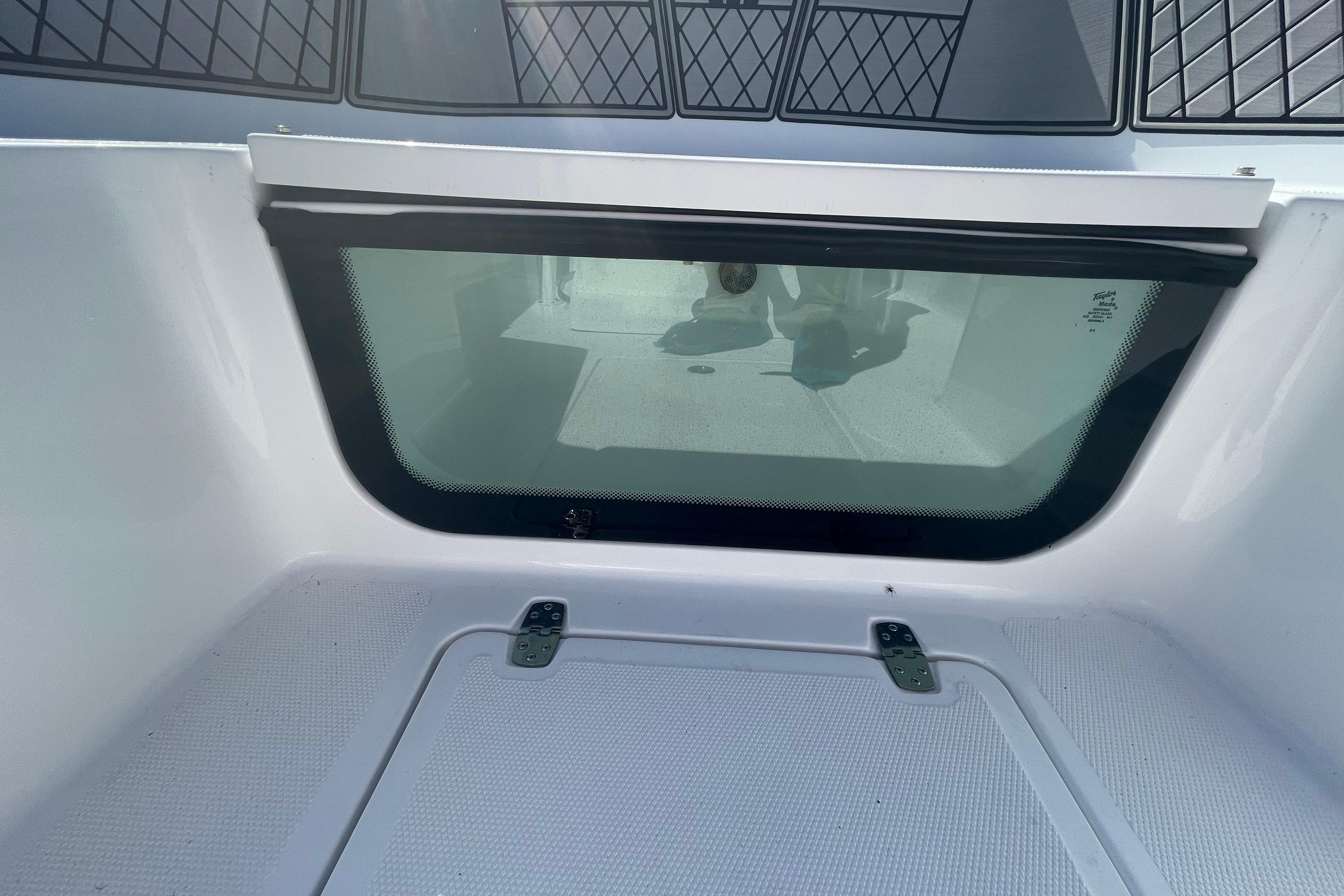 2022 Wellcraft 202 Fisherman boat interior with storage compartment and window.