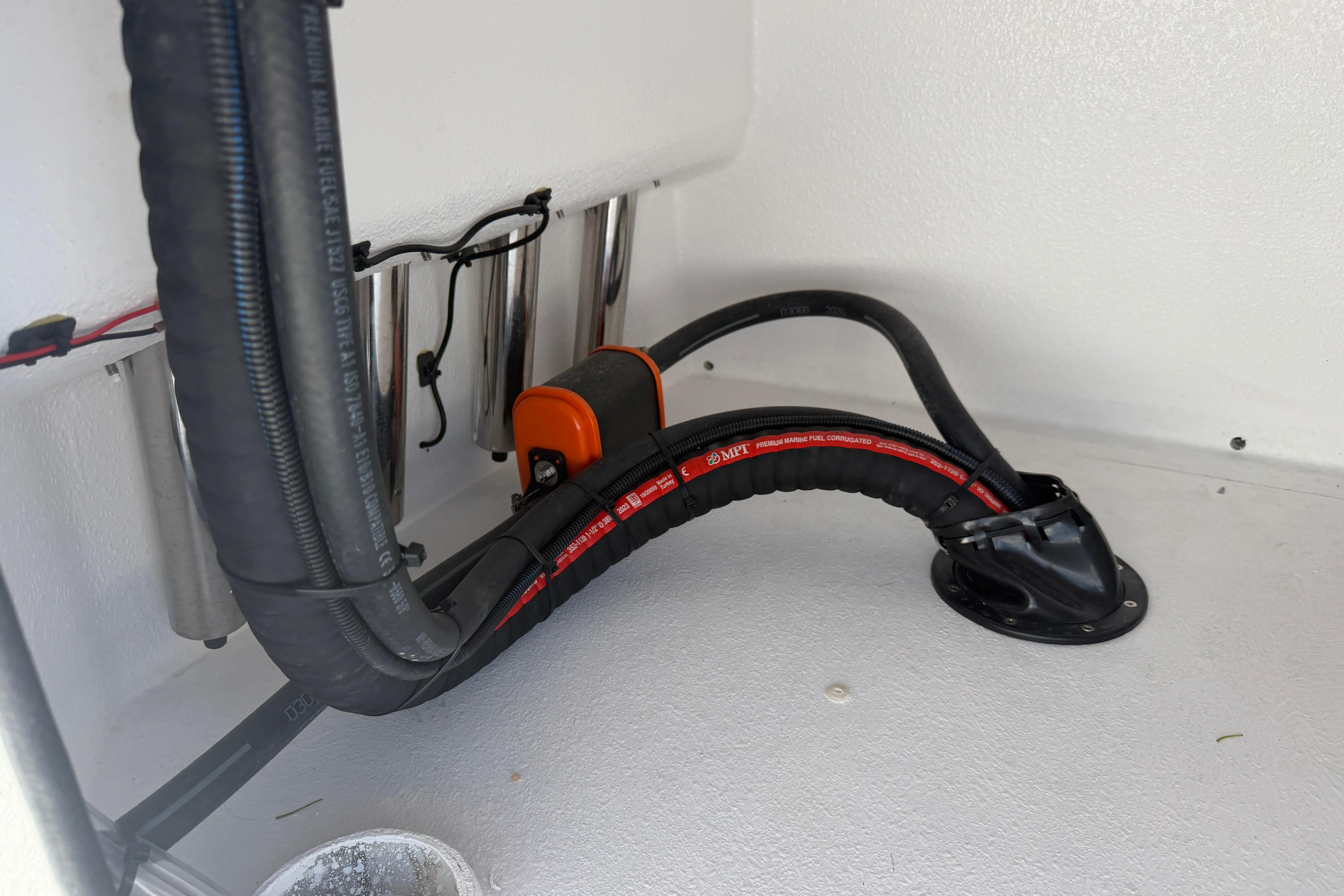Interior view of Skuta 24 Cat 2026, showcasing wiring and hose setup.