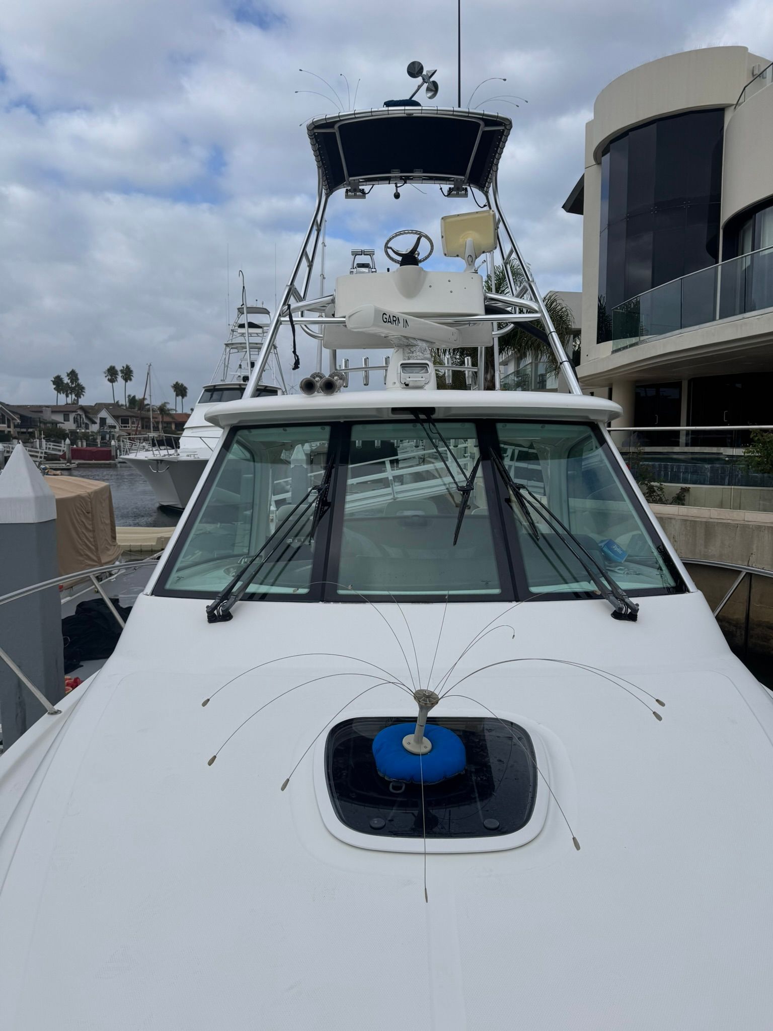 A 2008 Boston Whaler 345 Conquest docked at a marina. It features a spacious deck and flybridge.