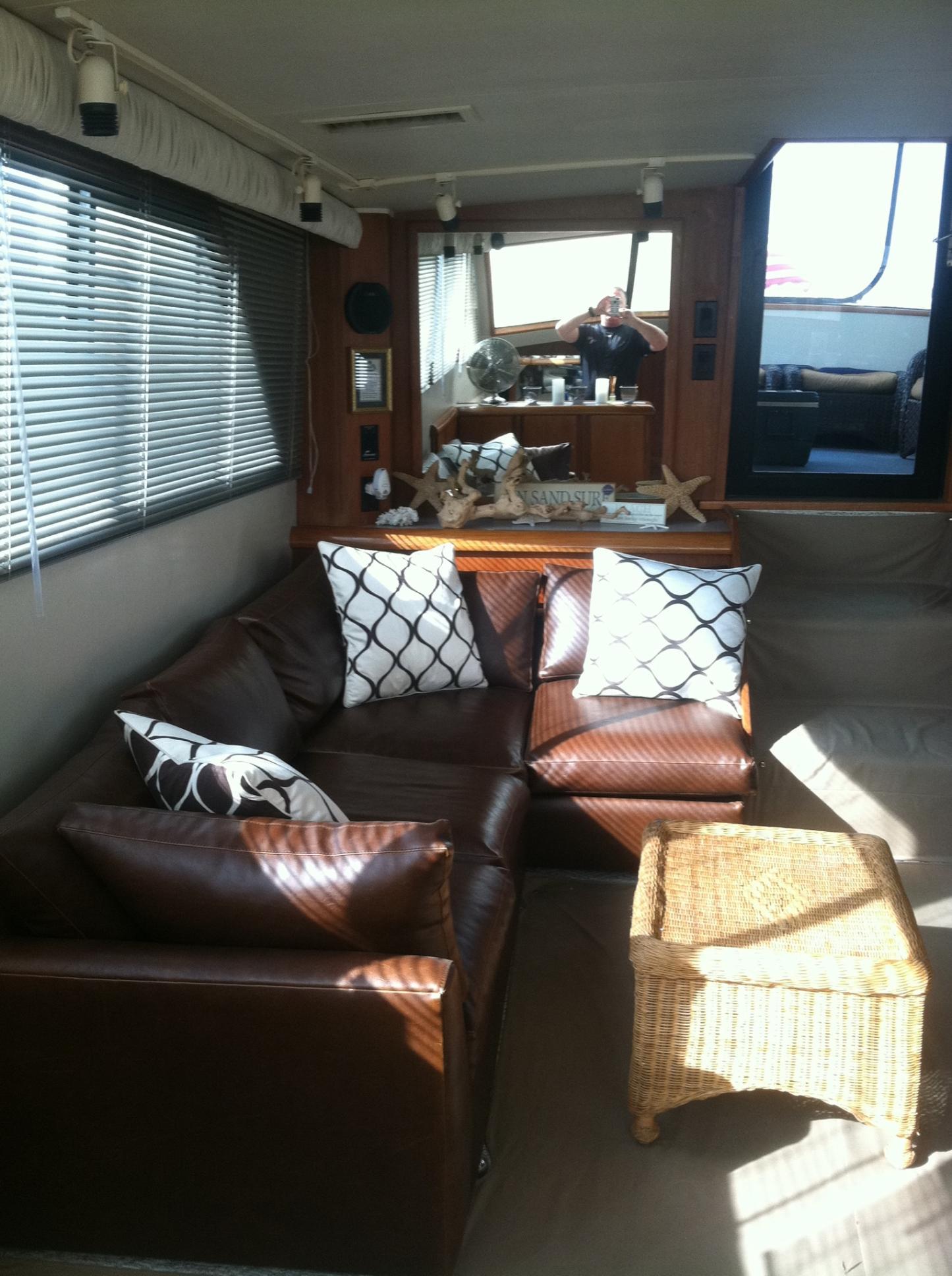 Interior of 1989 Californian 48 Motor Yacht with leather seating and wicker table.