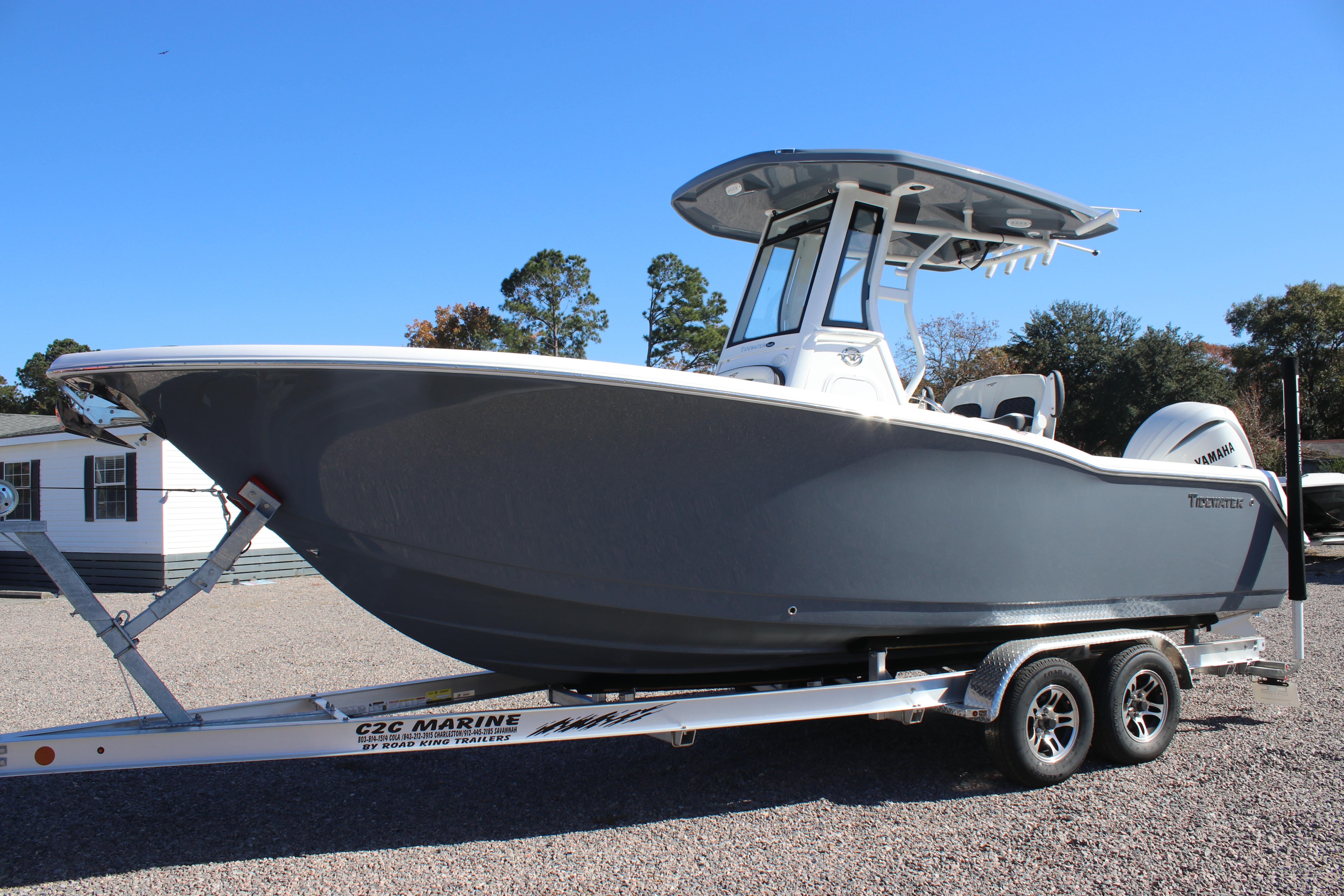 2026 Tidewater 232 CC Adventure boat on trailer, sleek design, clear blue sky background.