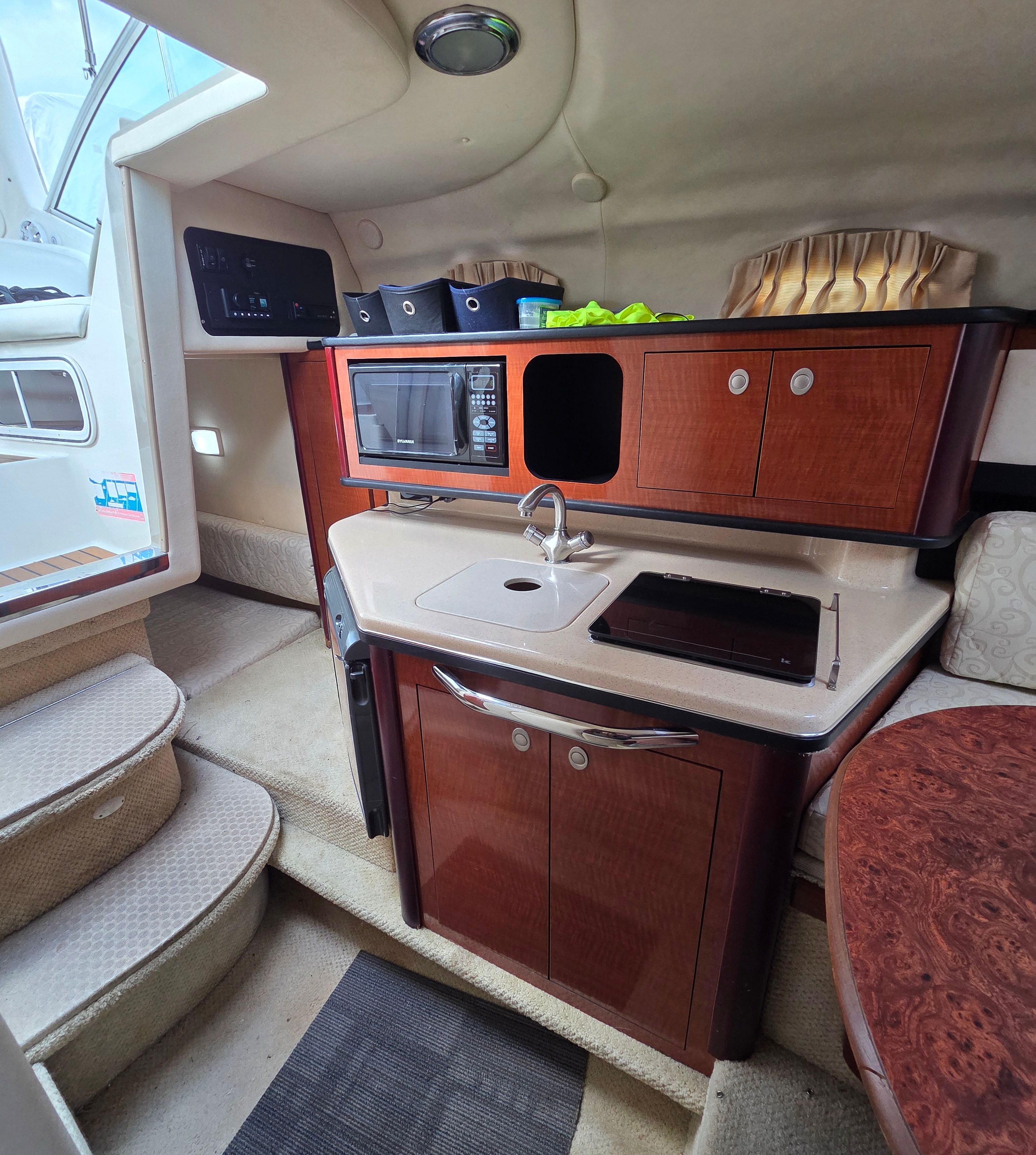Galley of the 2005 Sea Ray Sundancer 260 with microwave and sink.