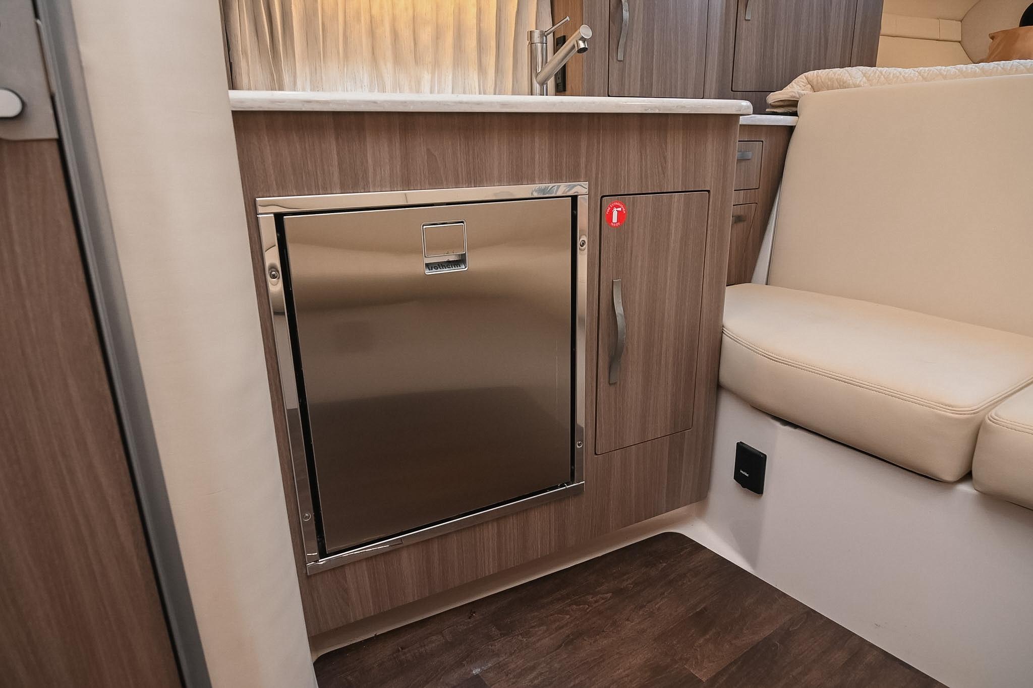 2021 Regal 33 Express yacht interior with modern kitchenette and seating area.