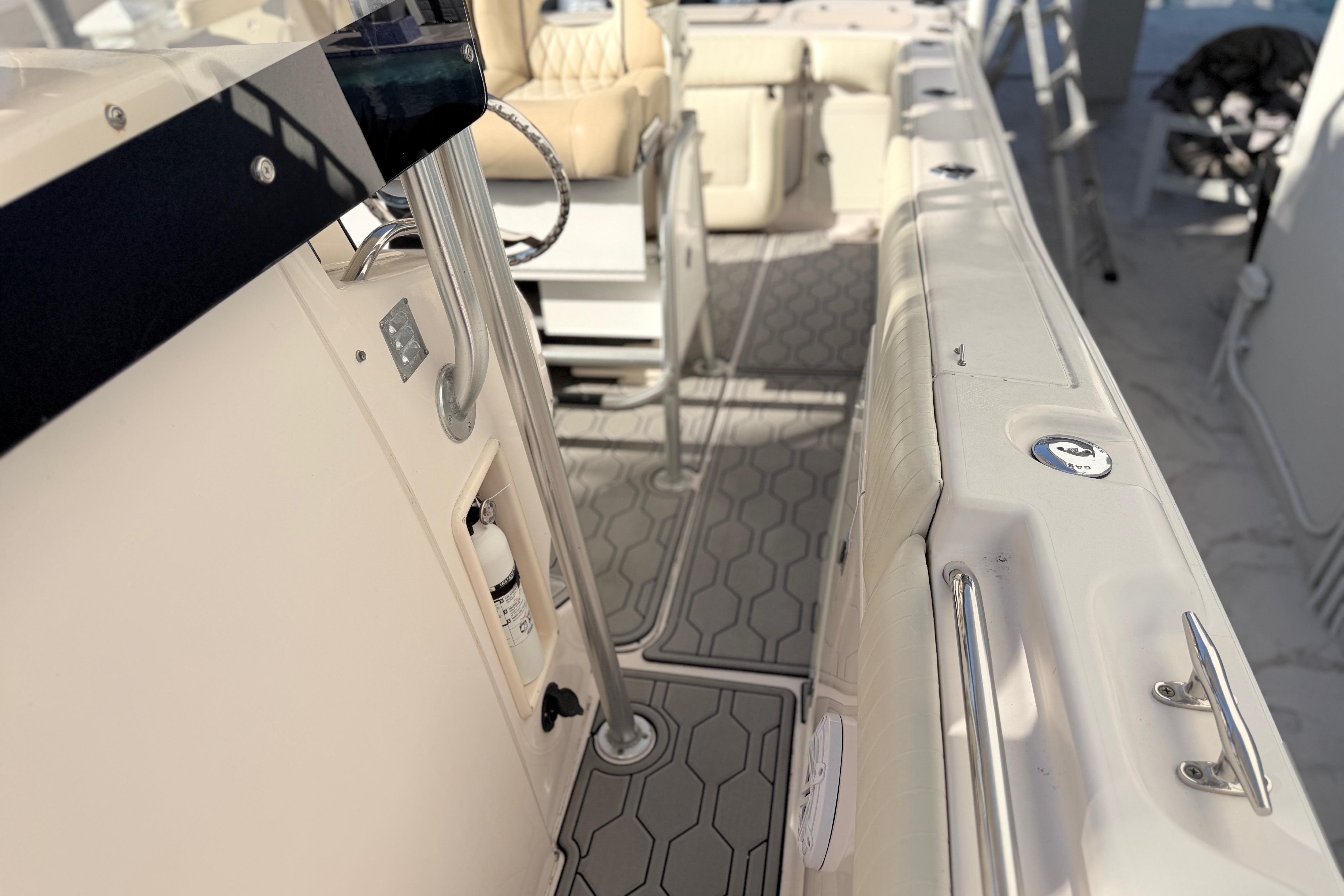2004 Grady White 273 boat interior with seating and safety equipment.
