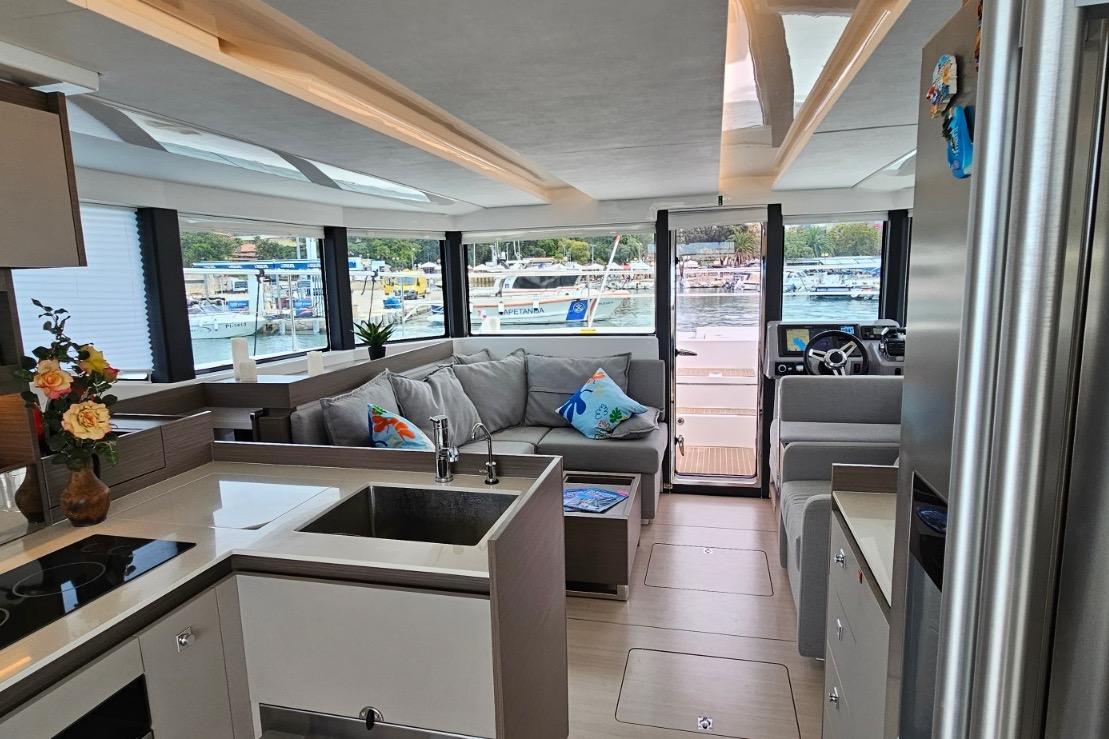 Interior of 2023 Leopard 40 Powercat yacht with modern kitchen and spacious seating area.
