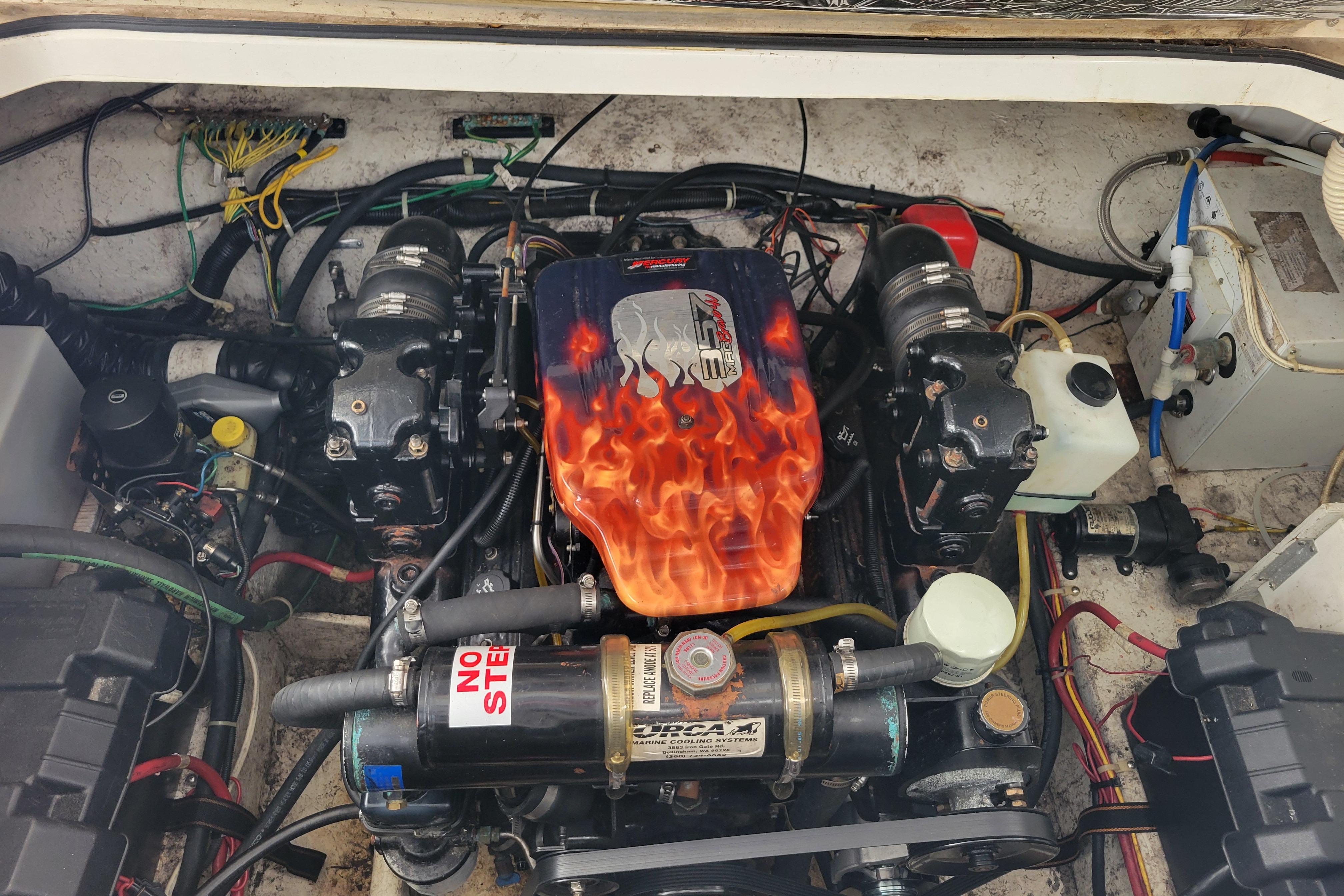 Engine compartment of a 2001 Bayliner 2655 Ciera with custom flame-painted cover.