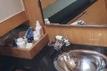 Compact bathroom in 2010 Mission-Craft Mis 35 boat with sink and toiletries.