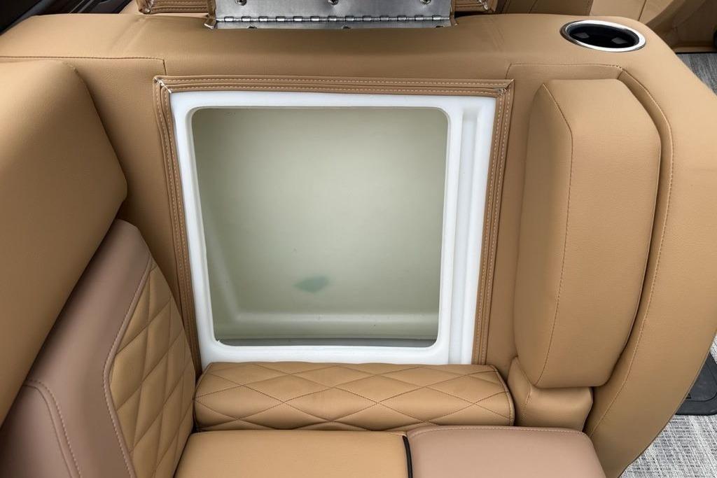 Luxurious tan seating on 2026 Godfrey Monaco 235 SFLC iMPACT boat, featuring integrated storage.