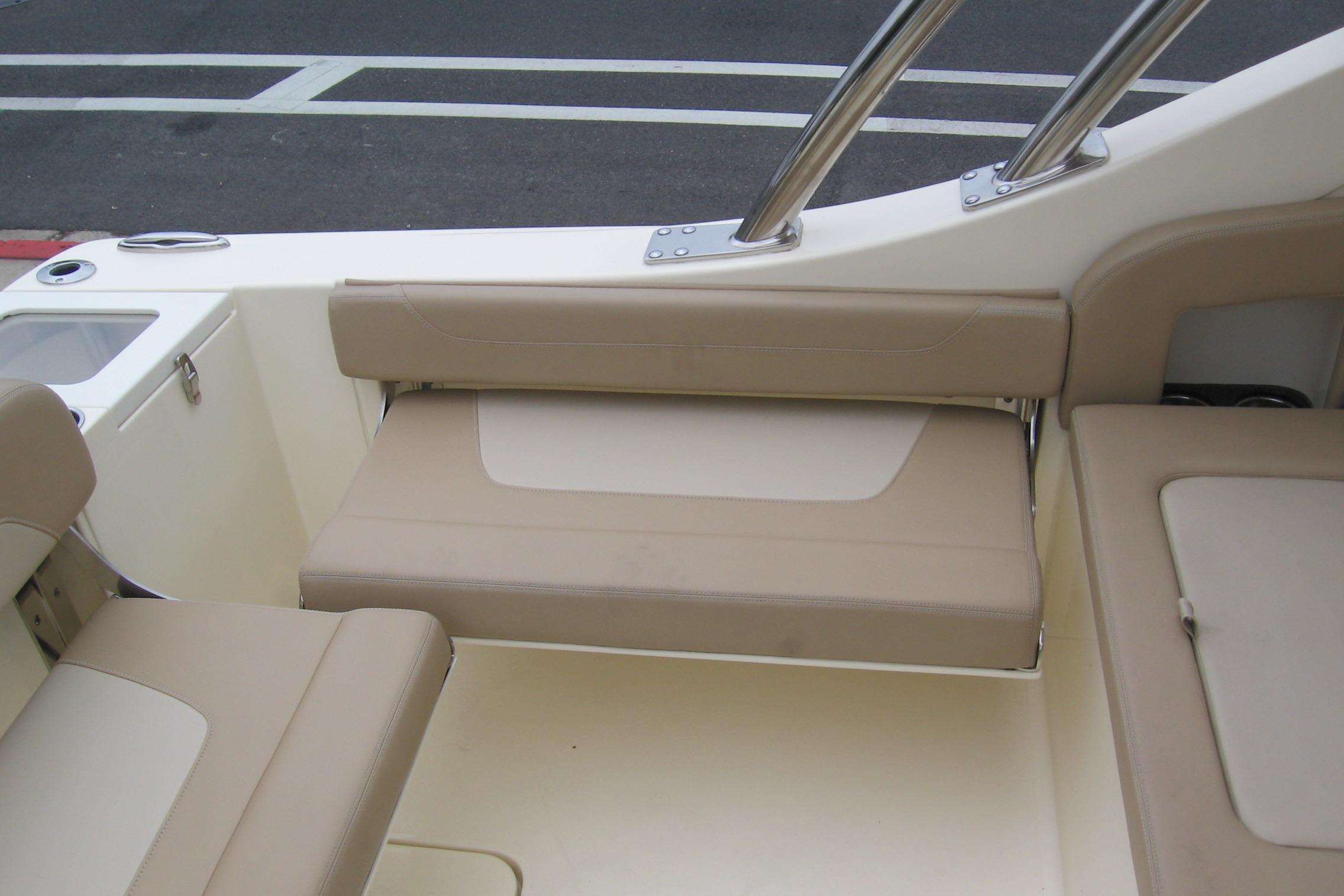 2024 Scout 255 Dorado boat interior with beige seating and stainless steel accents.