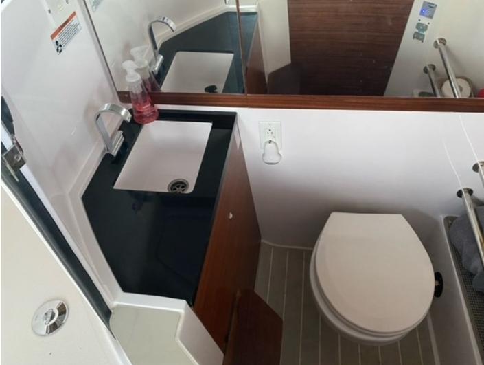 Bathroom interior of 2020 Axopar 28 boat with sink and toilet.