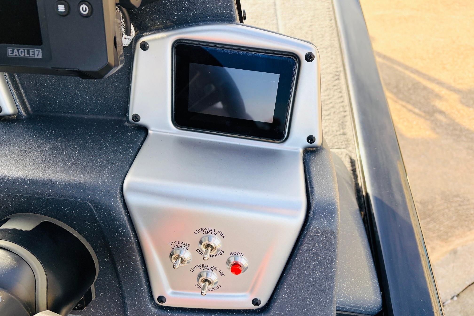 Control panel of 2025 Tracker Savage 215 boat with display and switches.