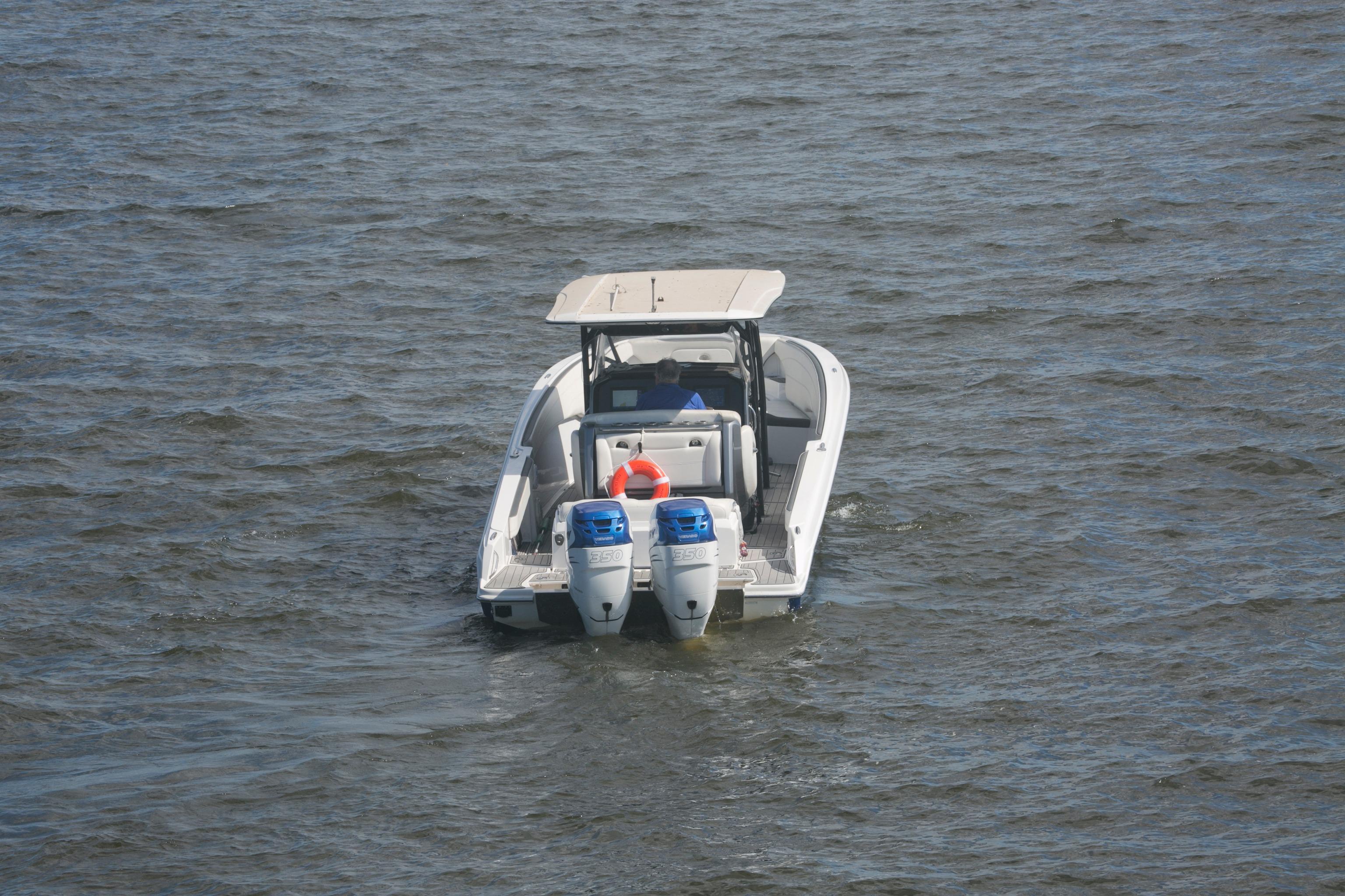 2018 Nor-Tech 340 Sport Center Console boat on open water, rear view.