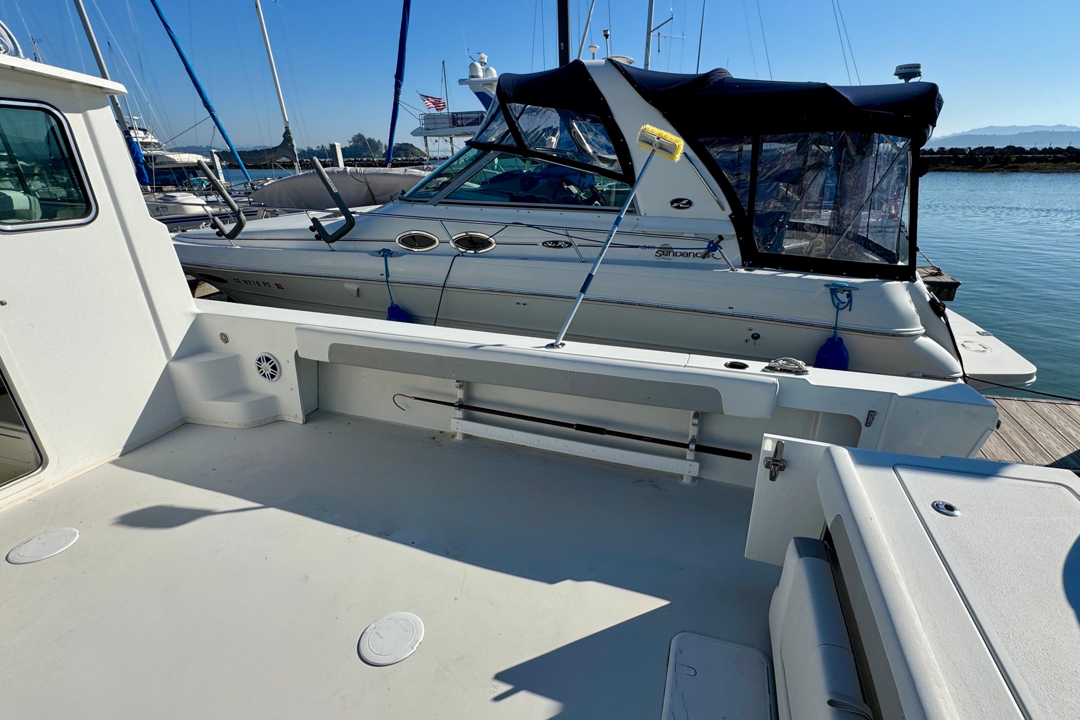 2021 Parker 2820 XLD Sport Cabin docked, showcasing spacious deck and nearby boats.