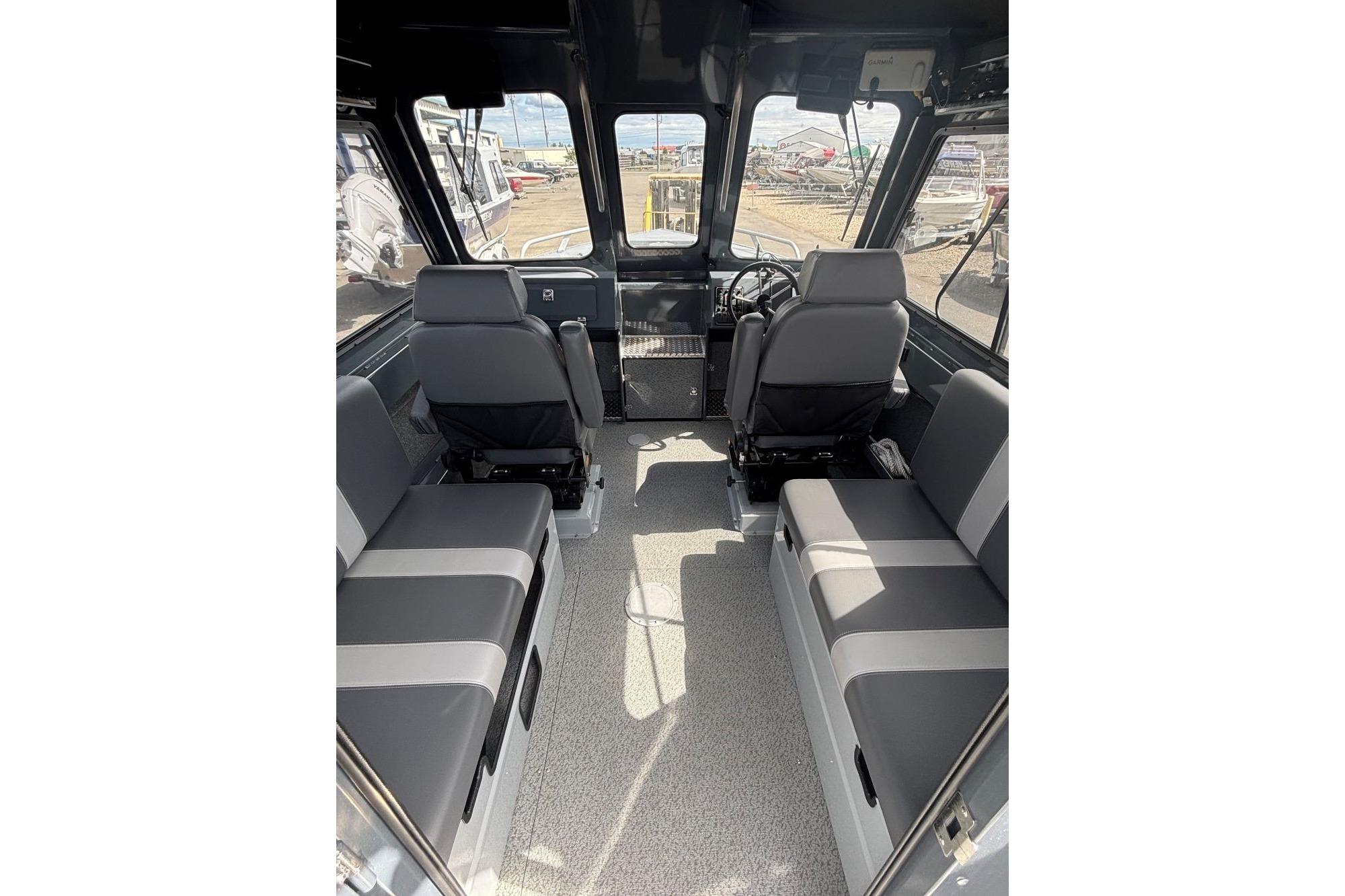2024 Hewescraft 240 Ocean Pro Hardtop interior with seating and steering wheel.