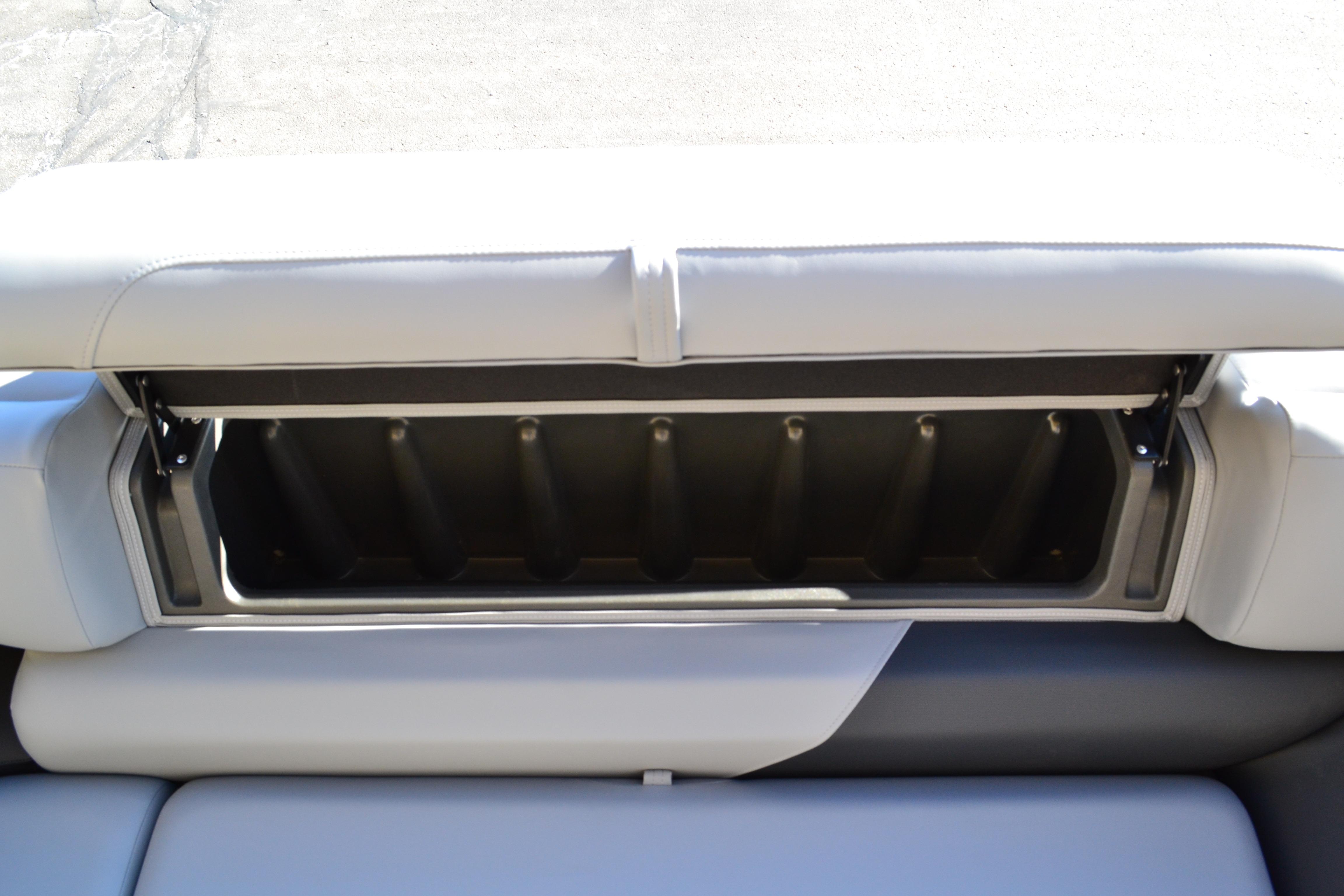 2026 Sun Tracker SportFish 22 XP3 boat seat storage compartment, open and empty.