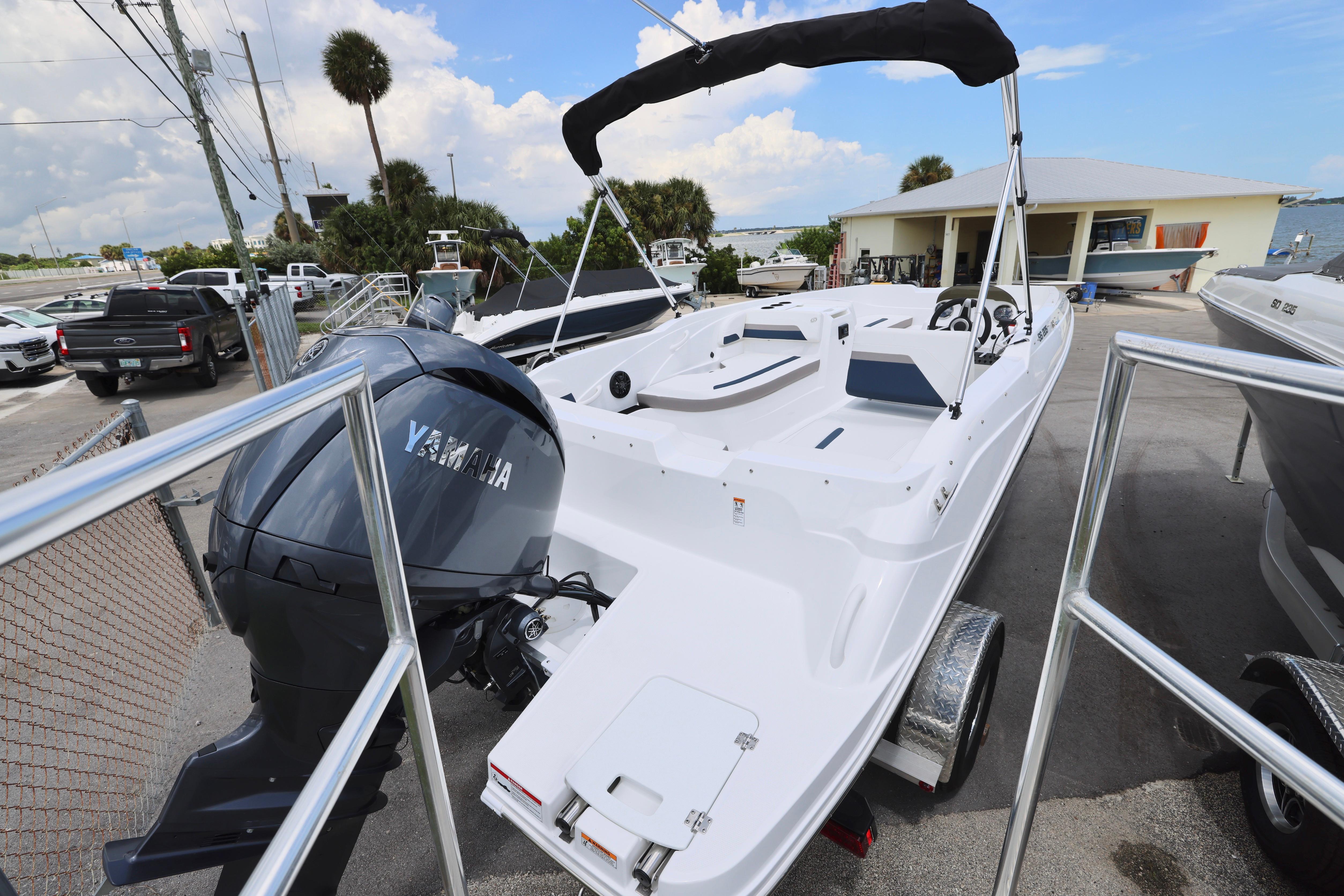 2026 Hurricane SunDeck Sport 205 OB boat with Yamaha outboard motor on trailer.