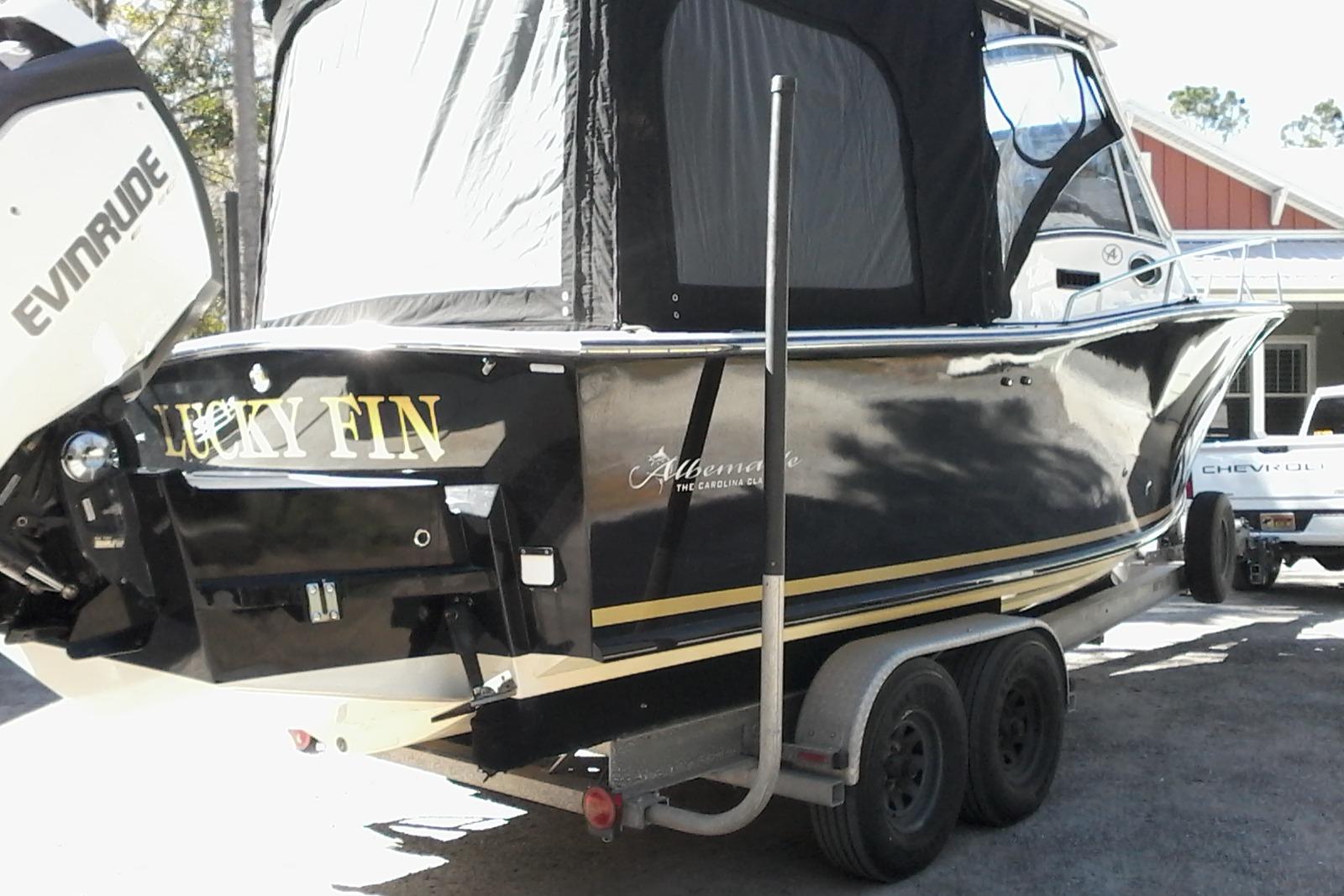 2002 Albemarle 265 Express Fisherman boat on trailer, featuring Evinrude engine.