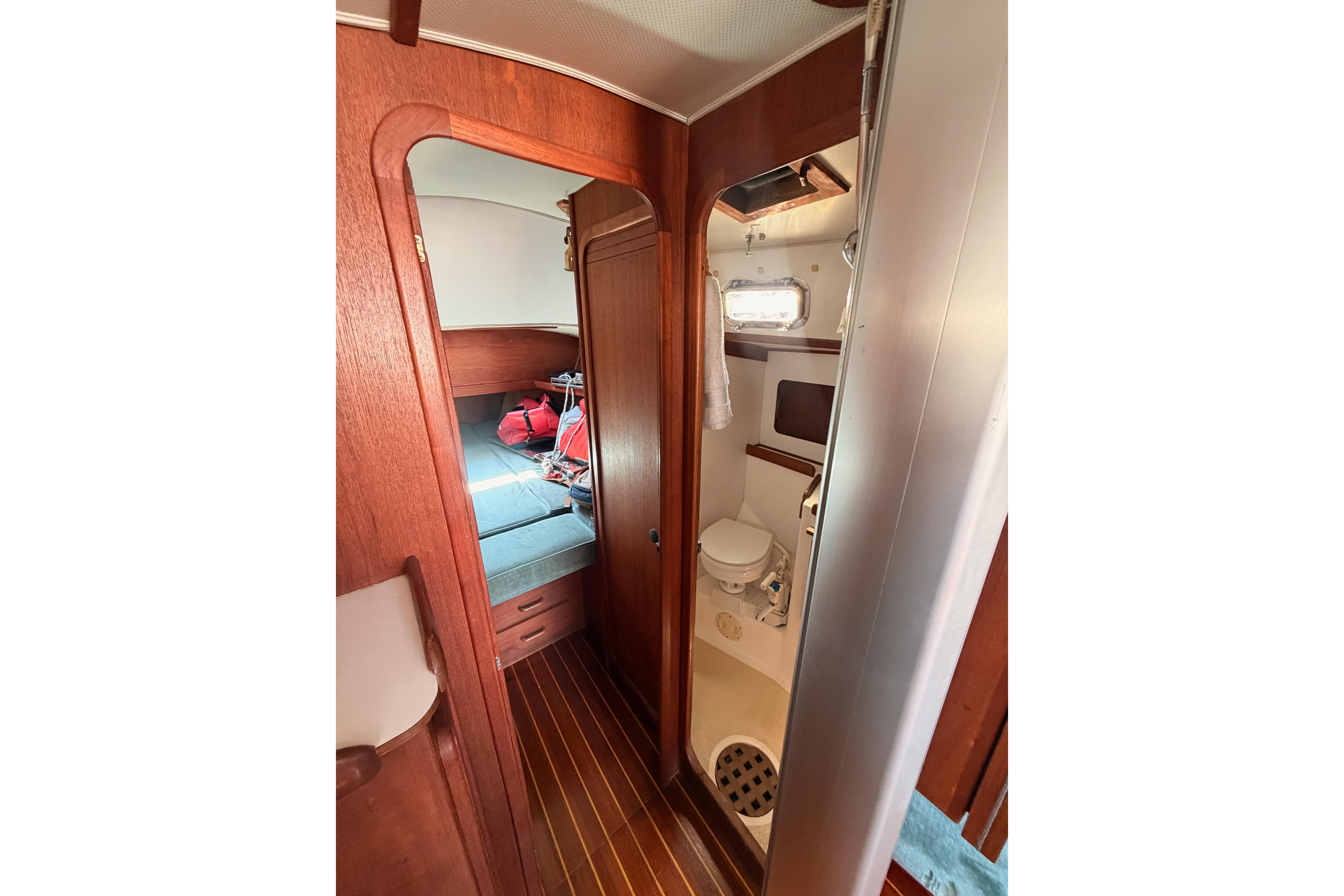 Interior of 1991 Caliber 33 sailboat showing cabin and compact bathroom.