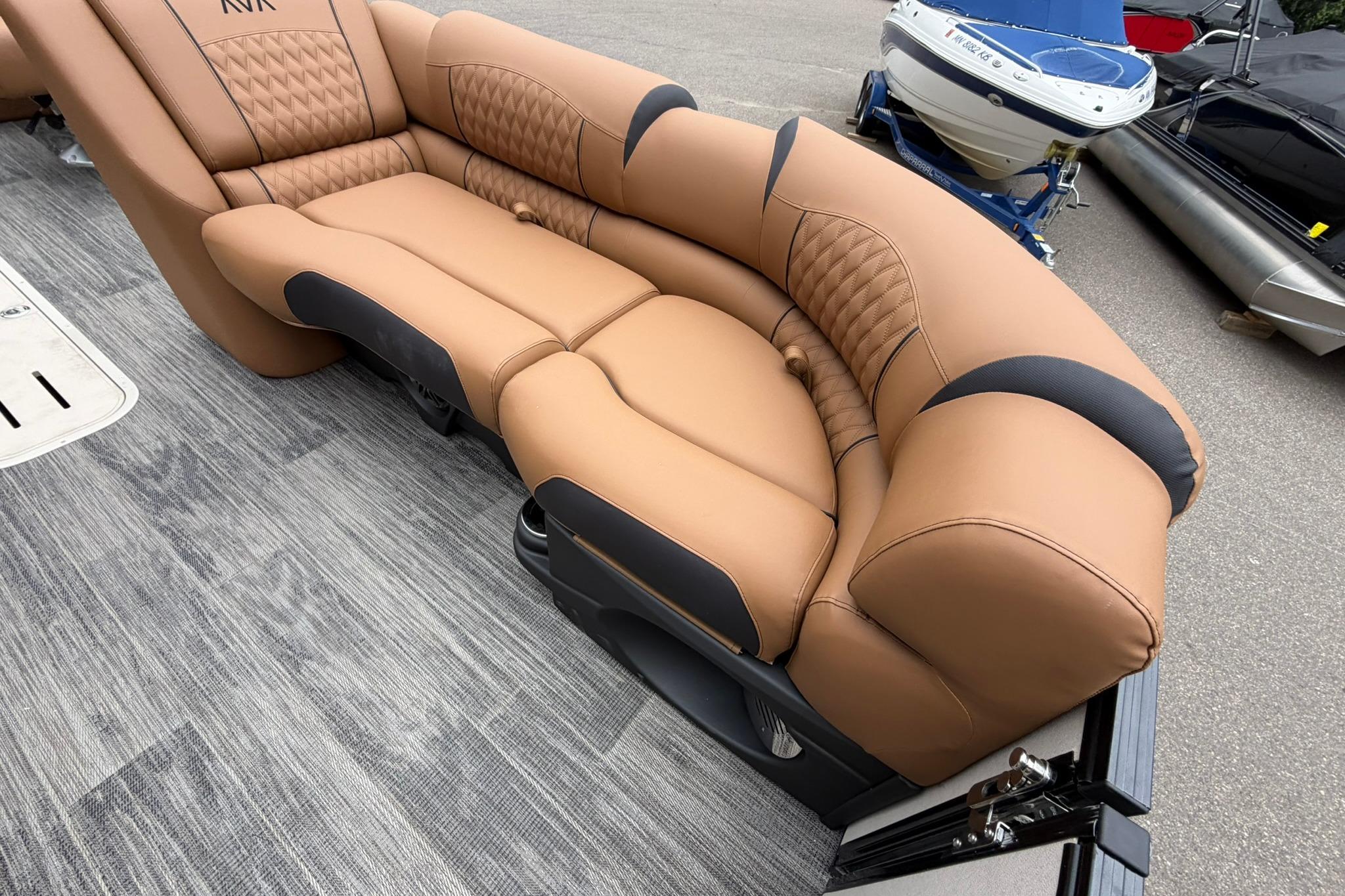 Luxurious seating on 2026 Avalon Catalina Quad Lounge Shift boat, featuring tan upholstery and modern design.