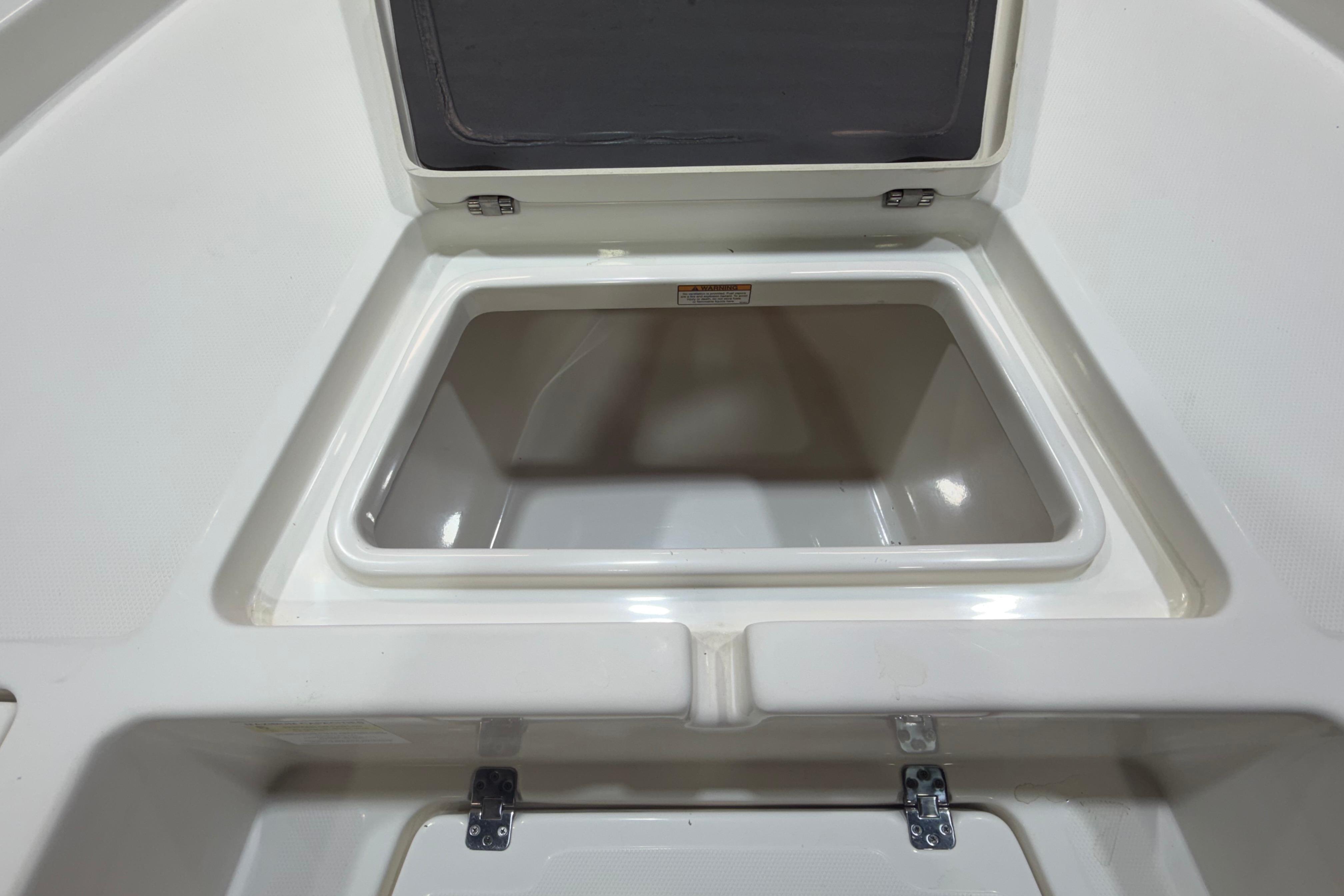 2023 NauticStar 215 XTS boat storage compartment, open and empty, showcasing interior space.