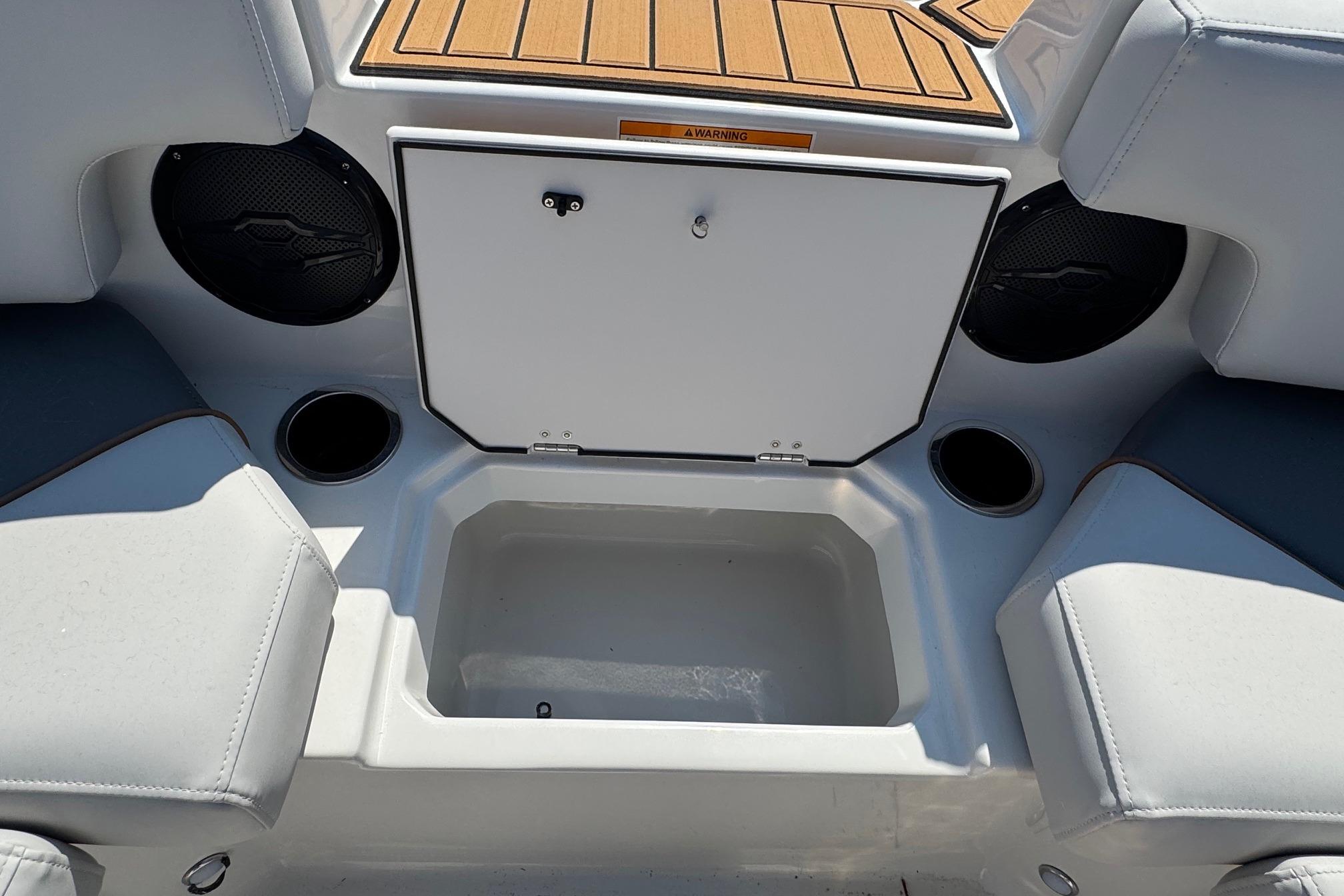 2026 Starcraft SVX 190 OB boat interior with storage compartment and cup holders.