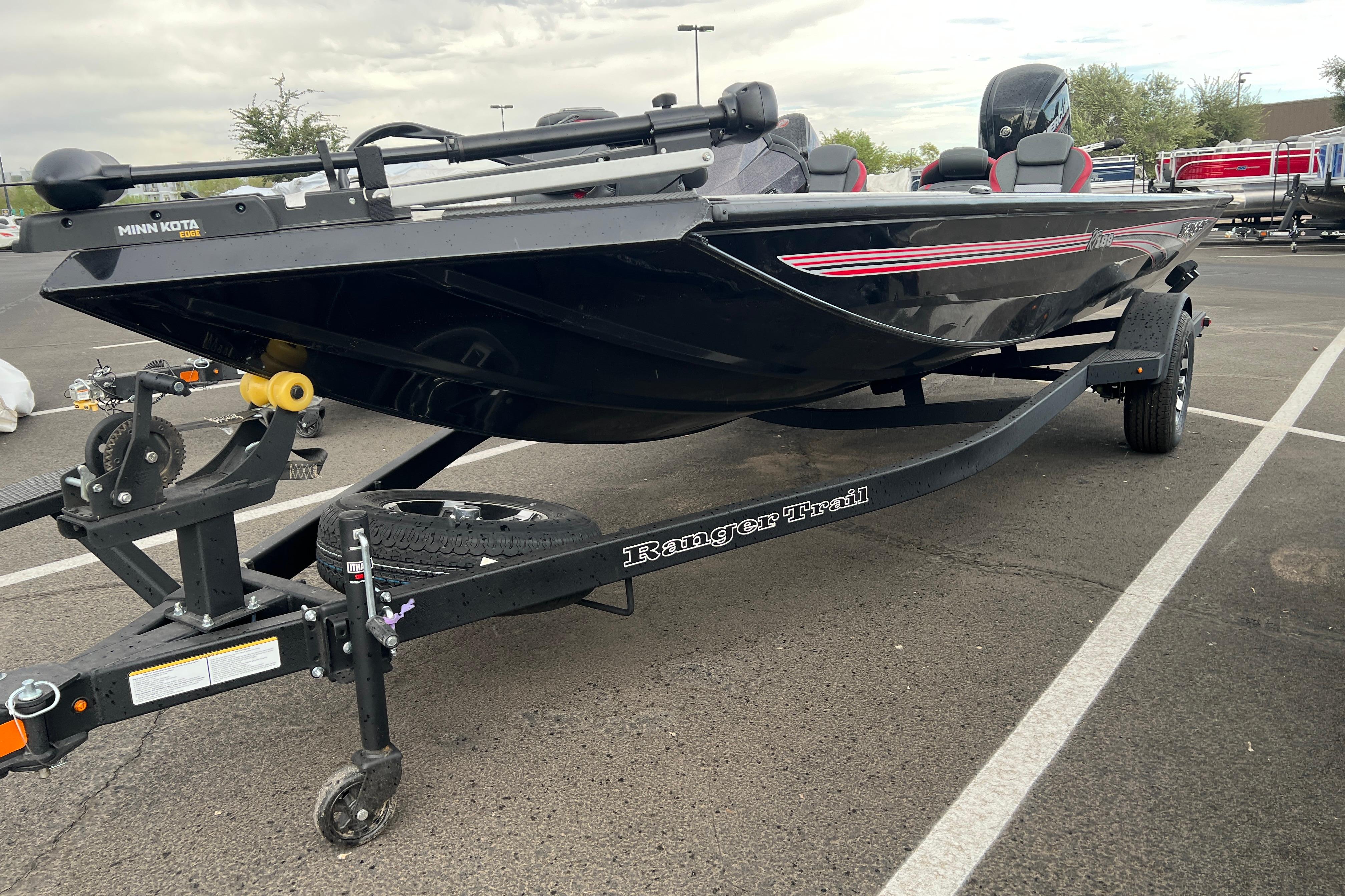 2026 Ranger RT188 boat on trailer in parking lot, featuring Minn Kota motor.