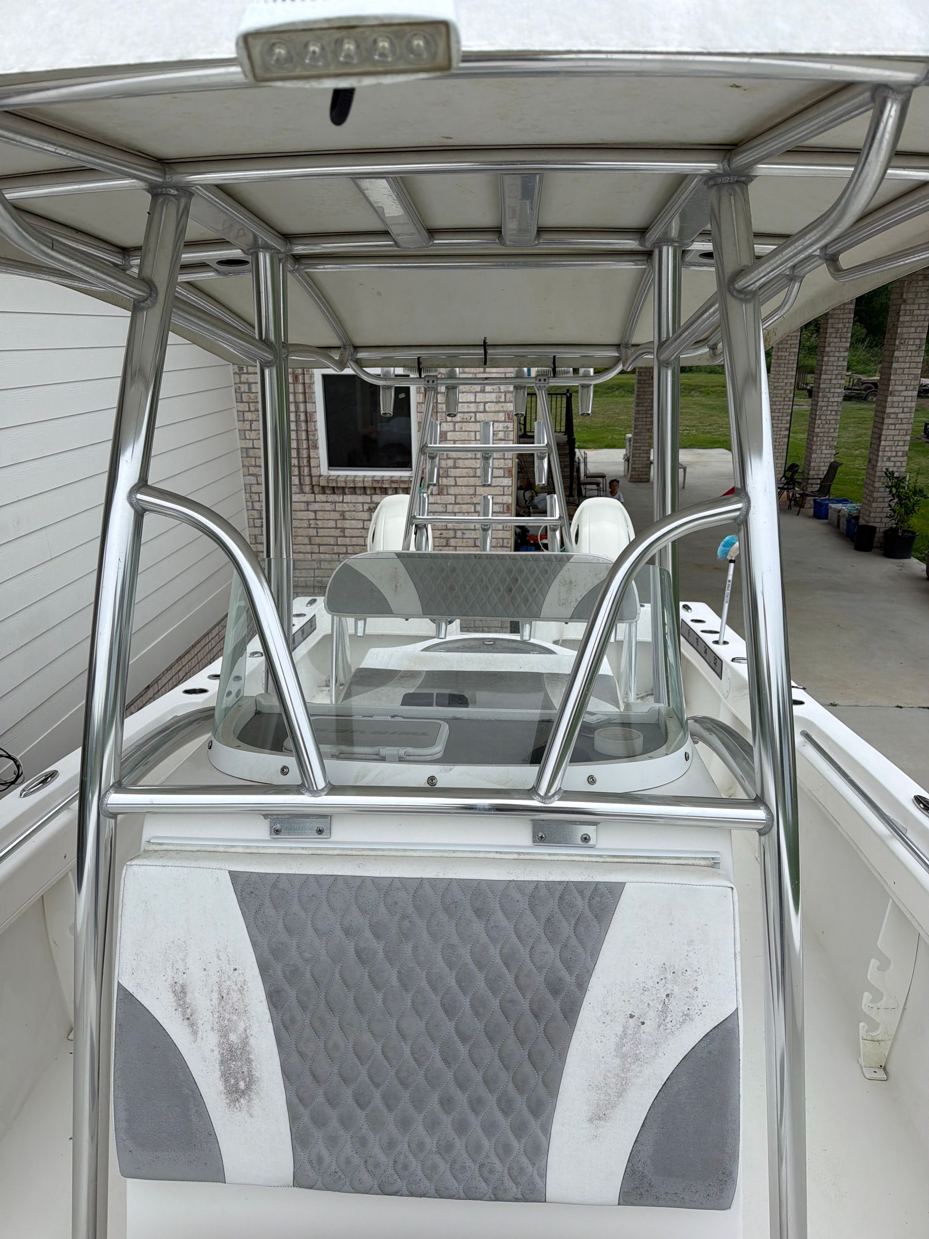 A Twin Vee Ocean Cat boat with aluminum frame and gray upholstery.