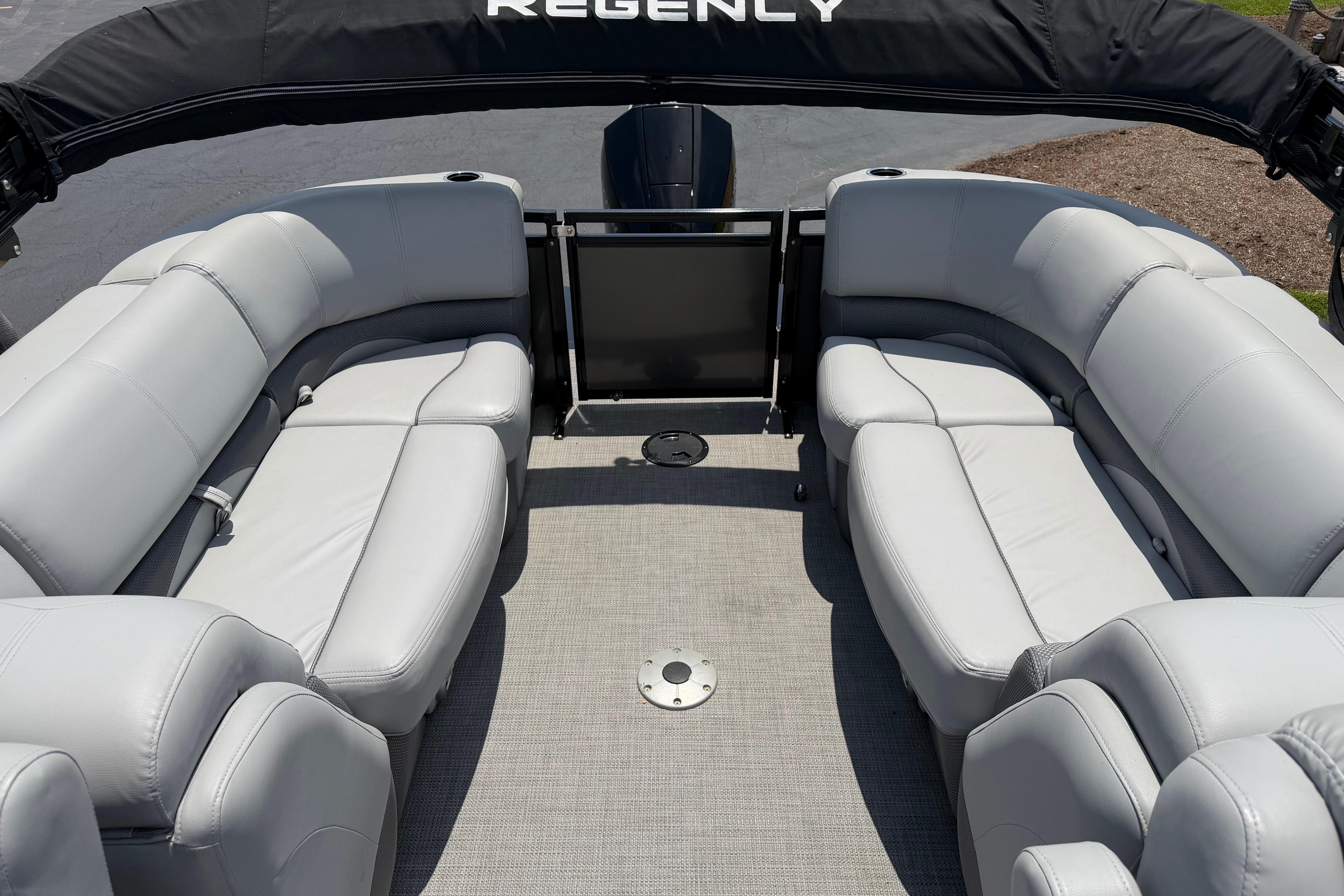 2019 Regency 230 DL3 pontoon boat interior with plush seating and spacious layout.
