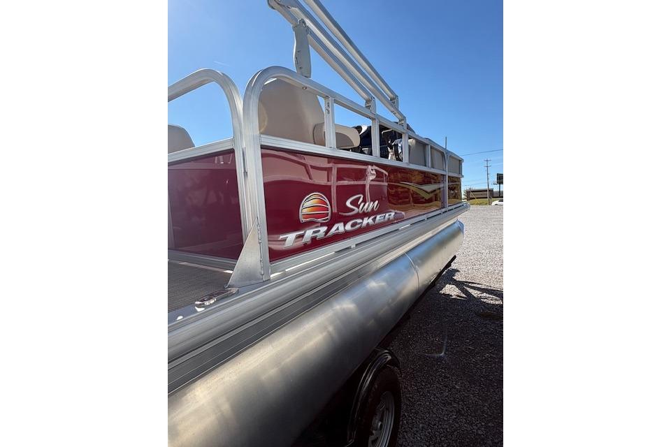 2025 Sun Tracker Party Barge 18 DLX pontoon boat with red exterior and logo.