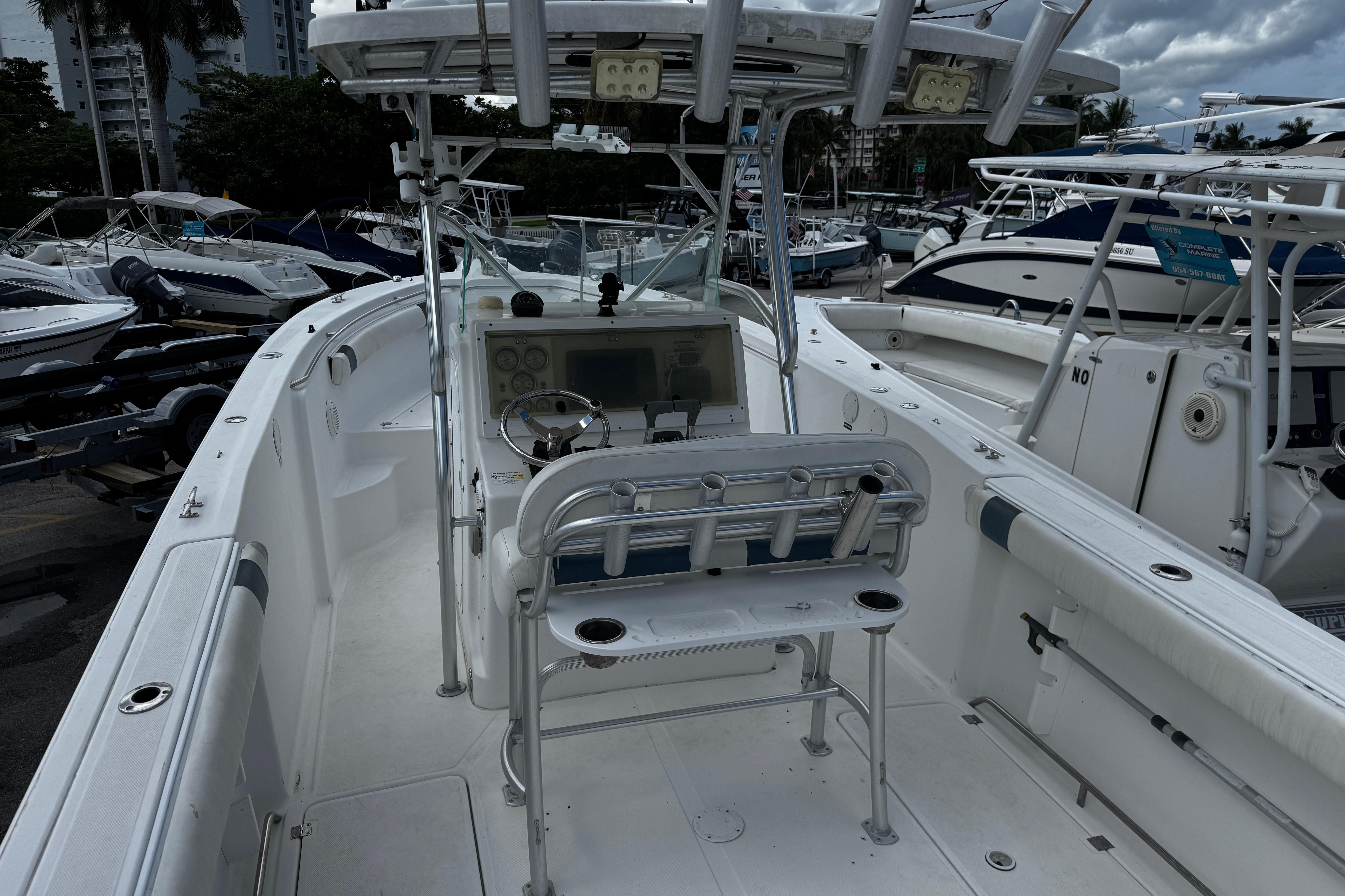 2008 Sea Fox 287 CC boat interior with helm, docked among other boats.