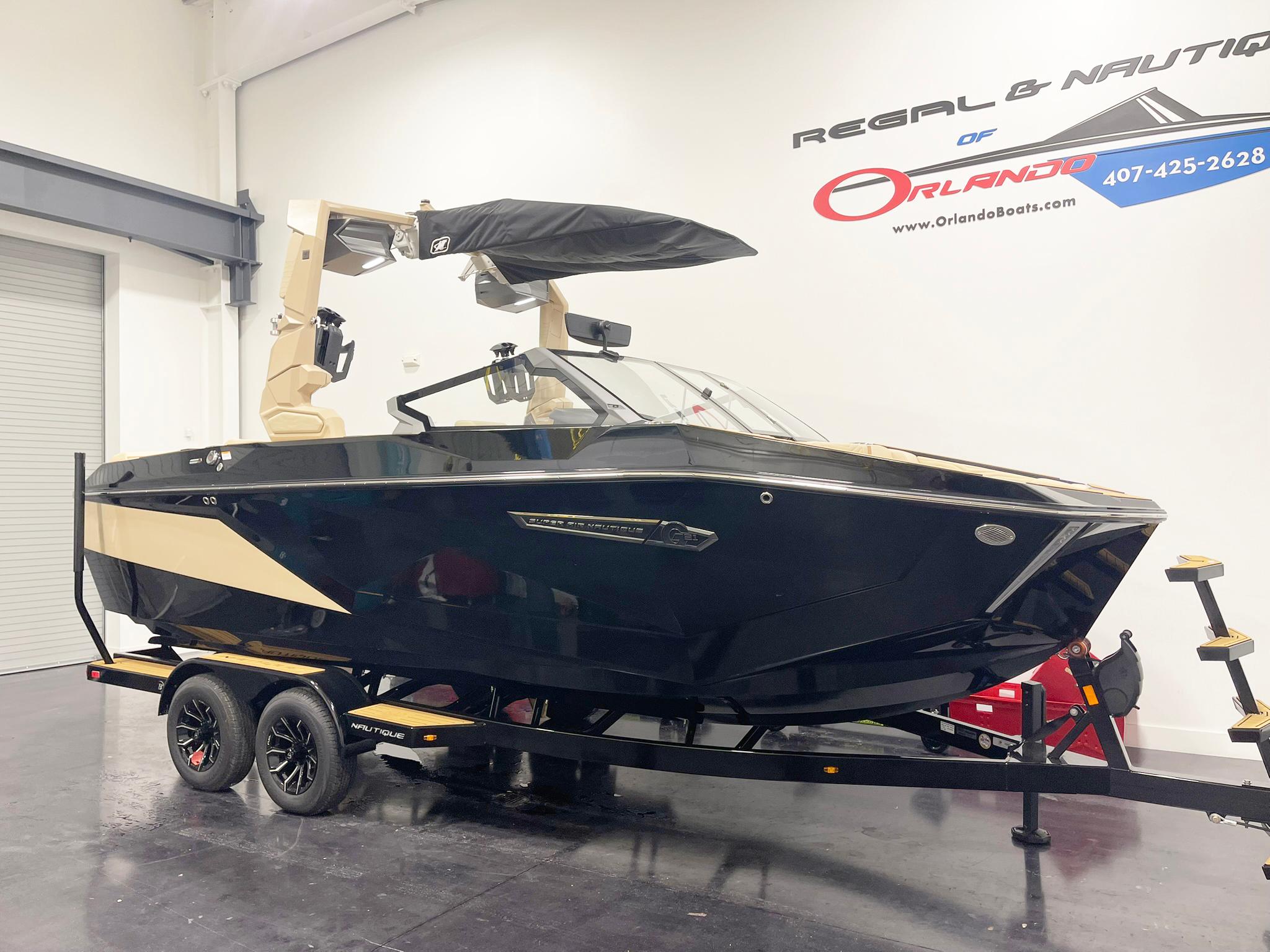 2025 Nautique Super Air Nautique G25 boat on trailer in showroom.