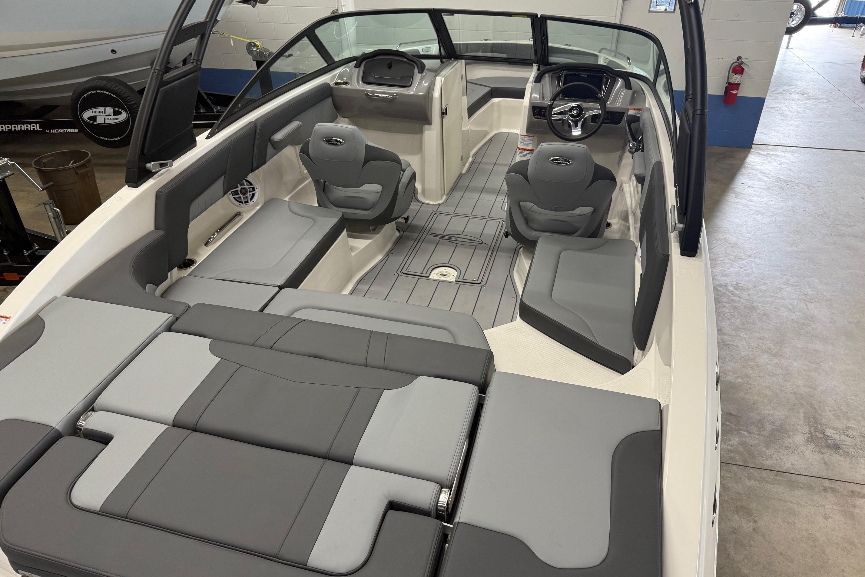 2026 Chaparral 23 SSi boat interior with gray seating and modern dashboard design.