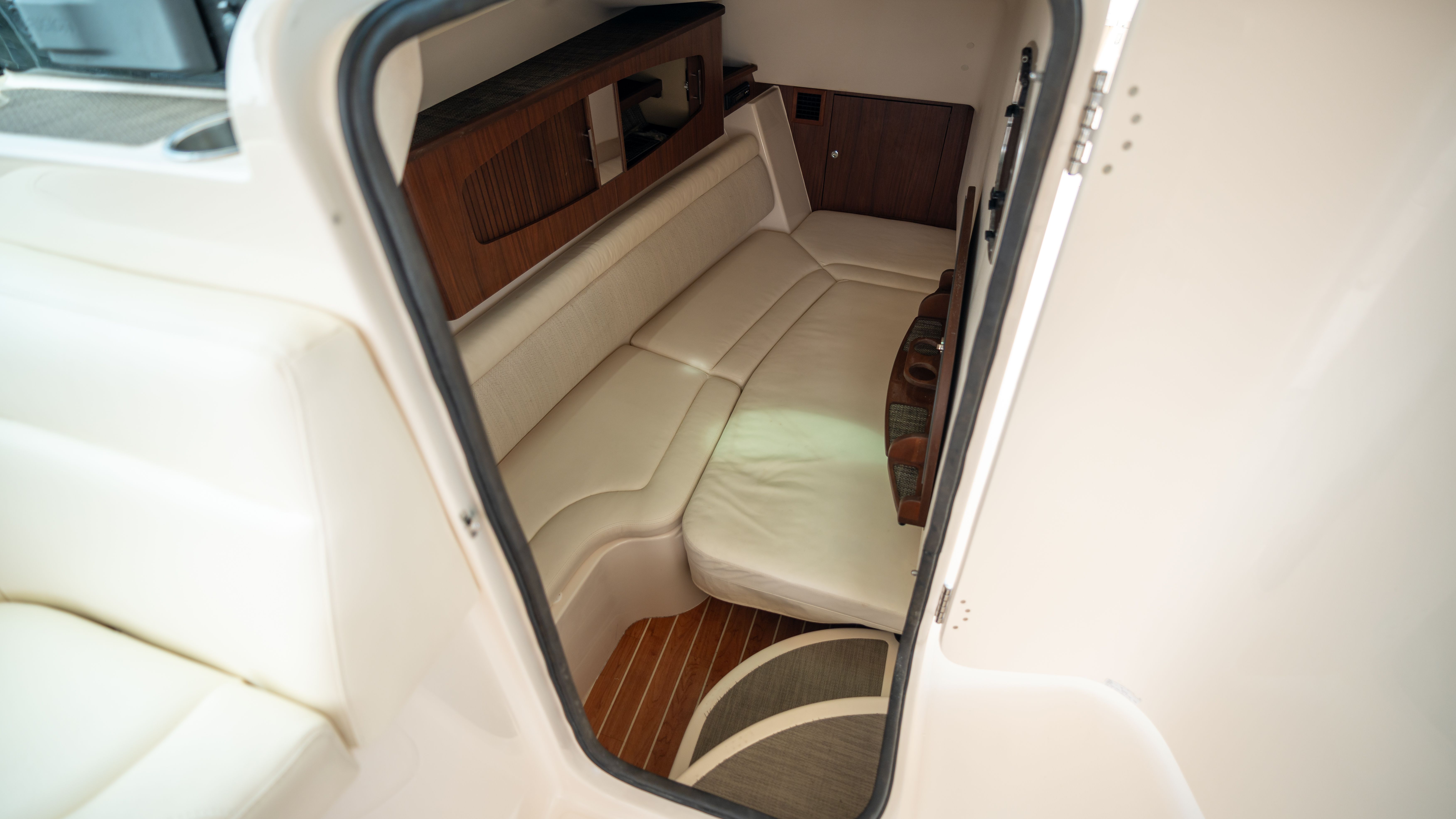 Interior of the 2019 Grady-White 375 Freedom with beige sofa and wood accents.