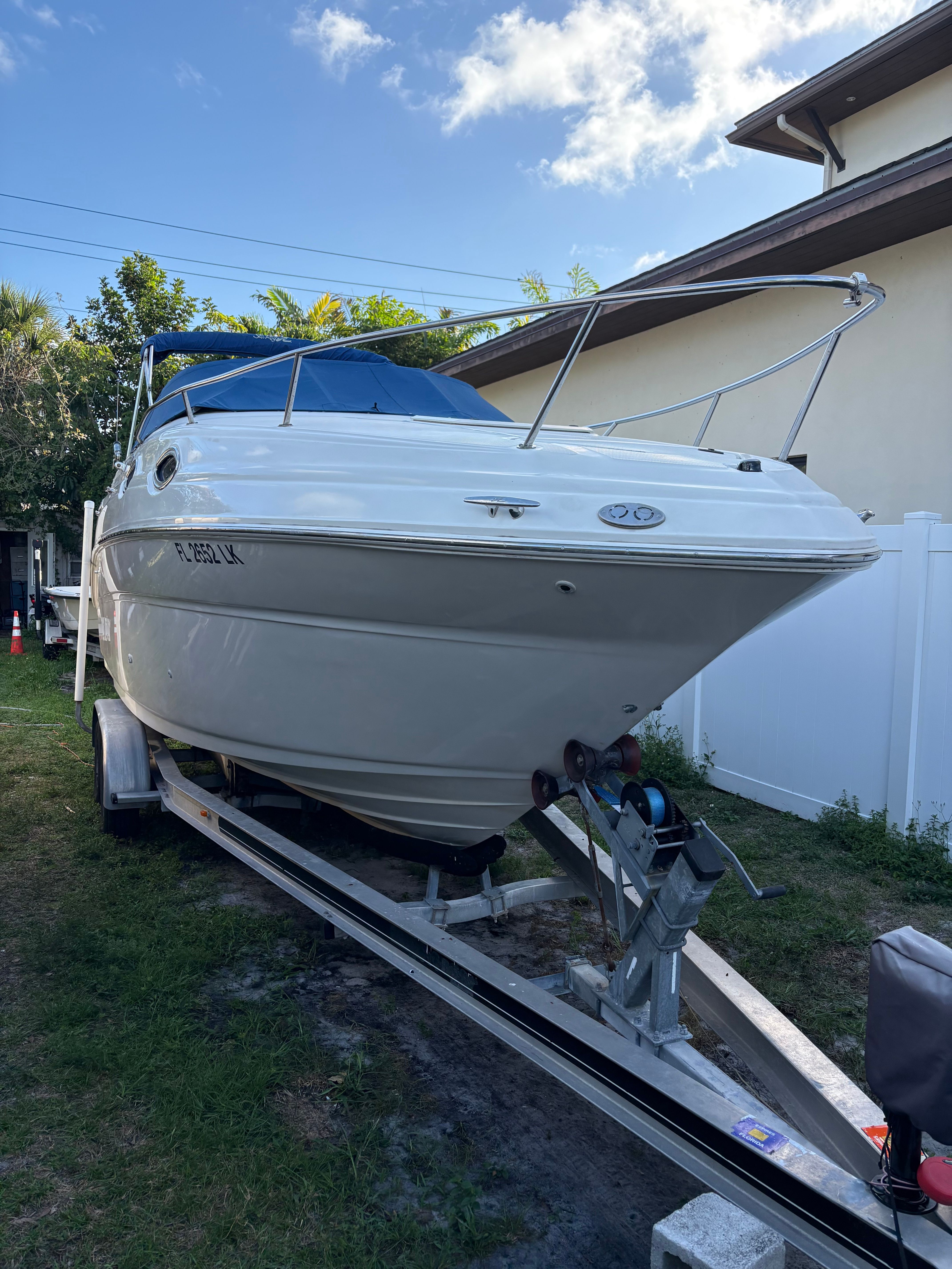 A 2001 Sea Ray 240 Sundancer on a trailer, ready for transport.
