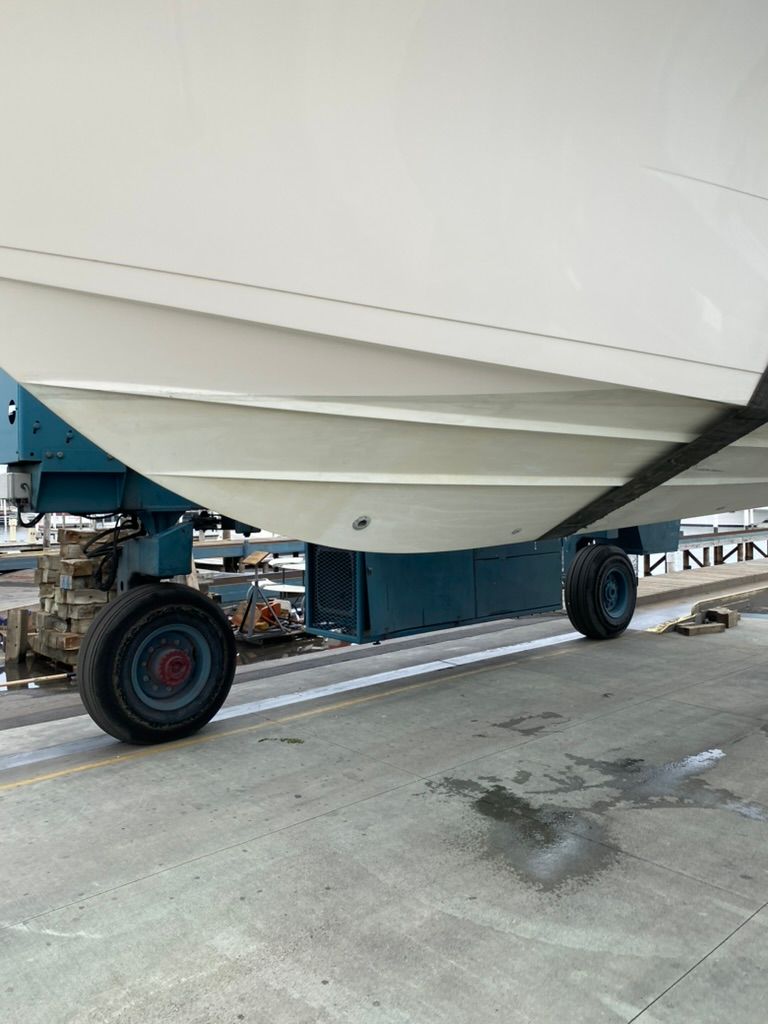 Underside of a 2023 Cobia 330 boat on a trailer.